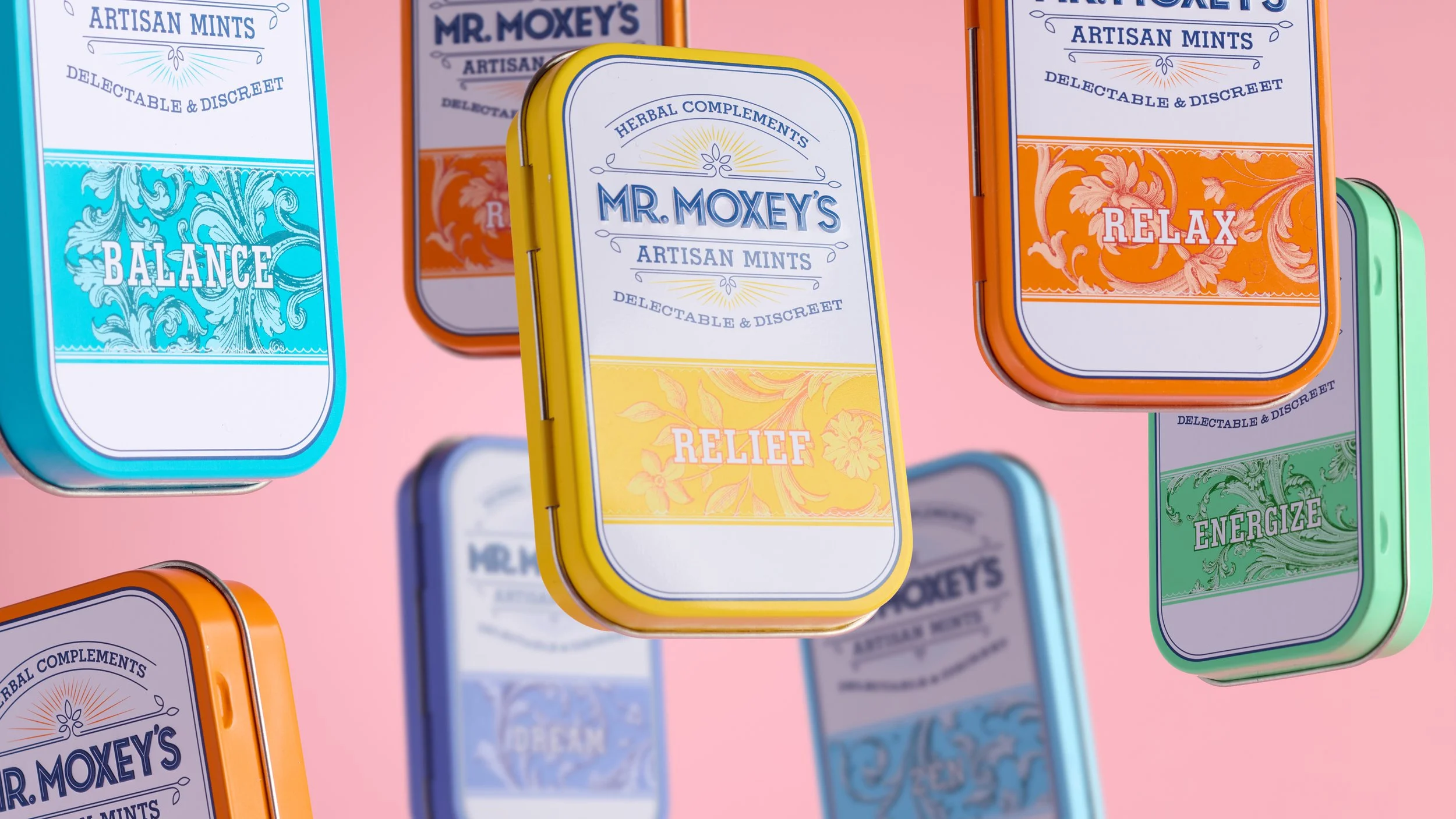 Mr. Moxey’s artisan mints packaging shown as colorful tins floating against a pink background