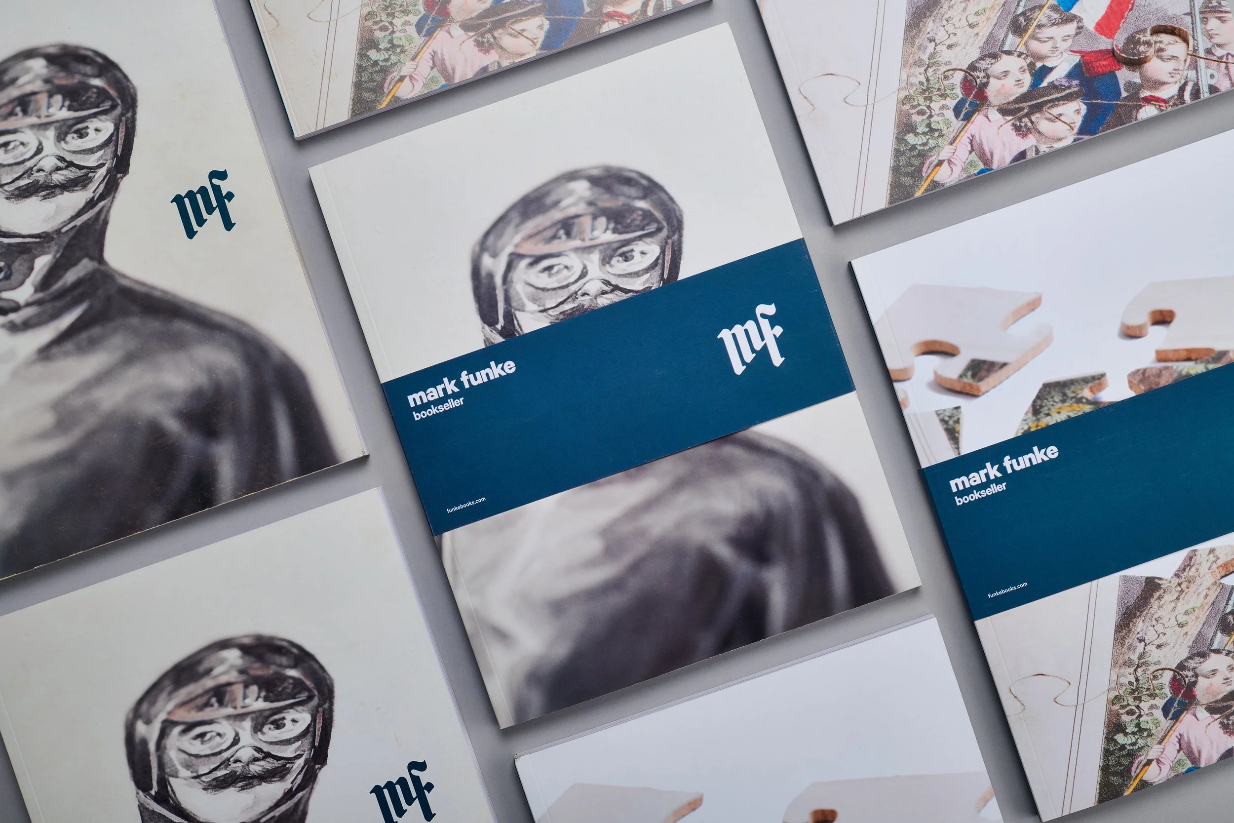 Mark Funke bookseller brand identity applied across a series of printed books with illustrated covers