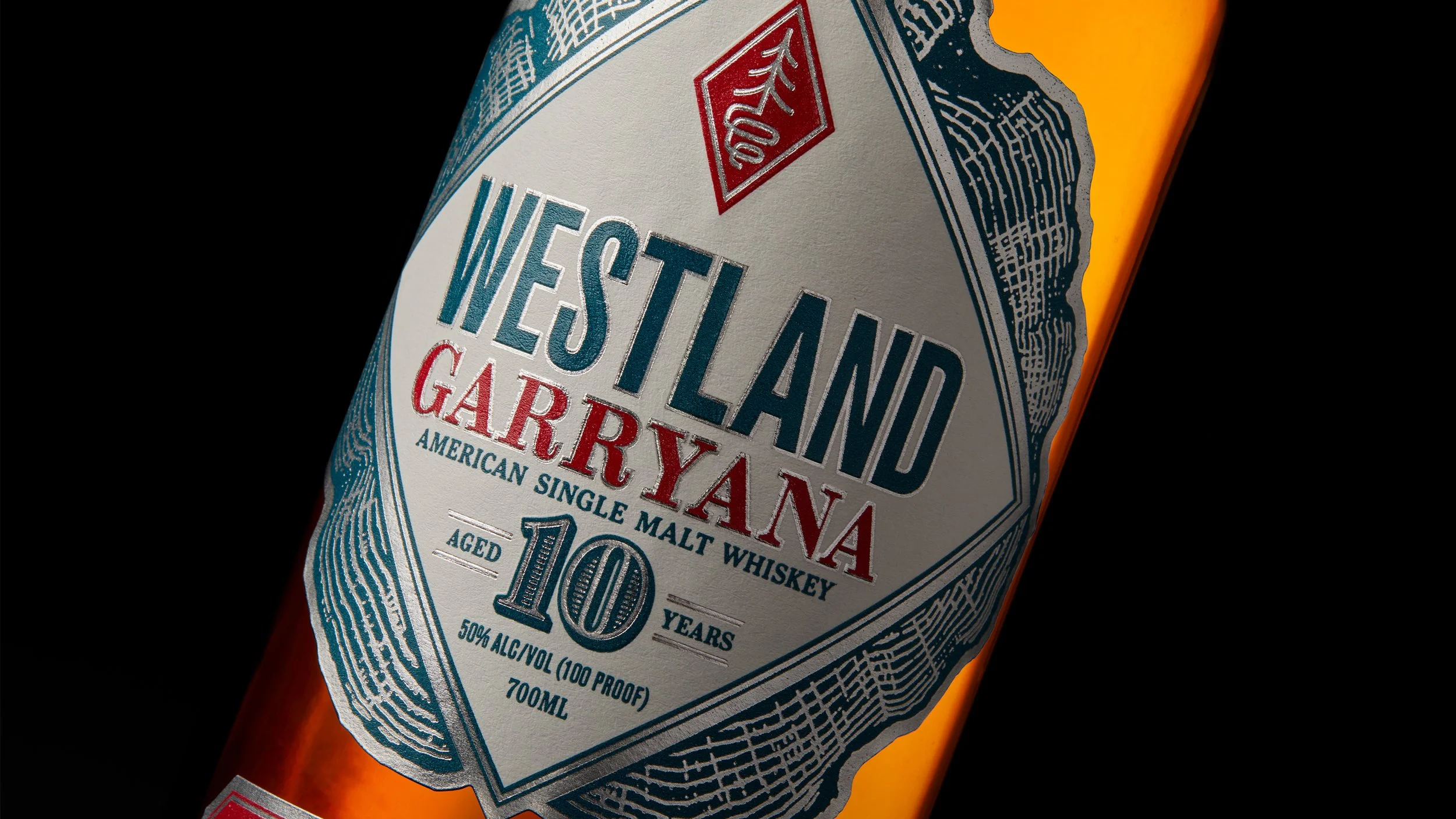 Close-up of a whiskey bottle label for Westland Garryana, an American single malt whiskey aged 10 years, with 50% alcohol by volume, on a black background.