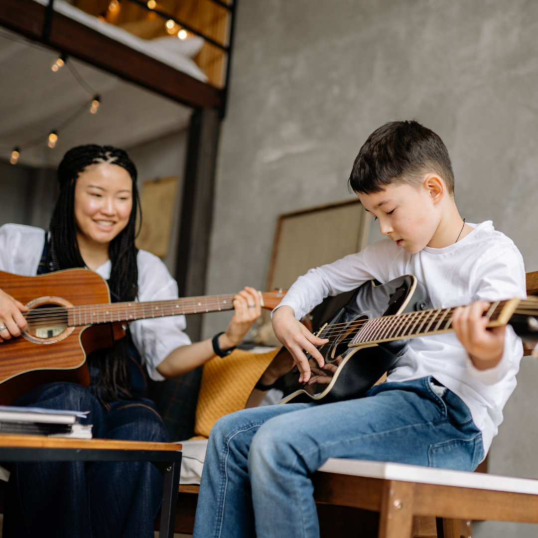 Beginner guitar student practicing chords with a Los Angeles Music Teachers instructor