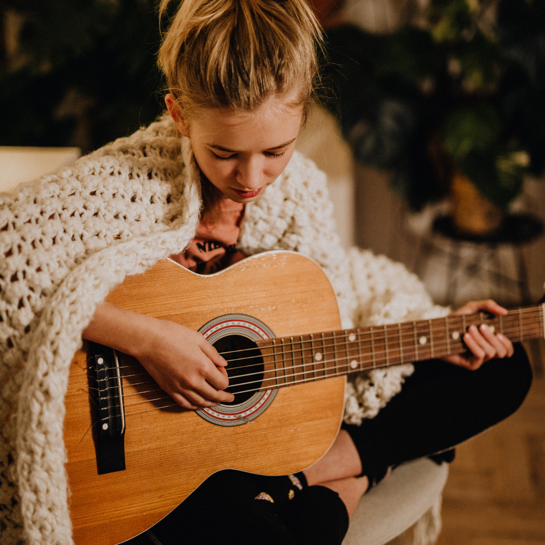 In home guitar lesson with a Los Angeles Music Teachers instructor helping a student with chord changes