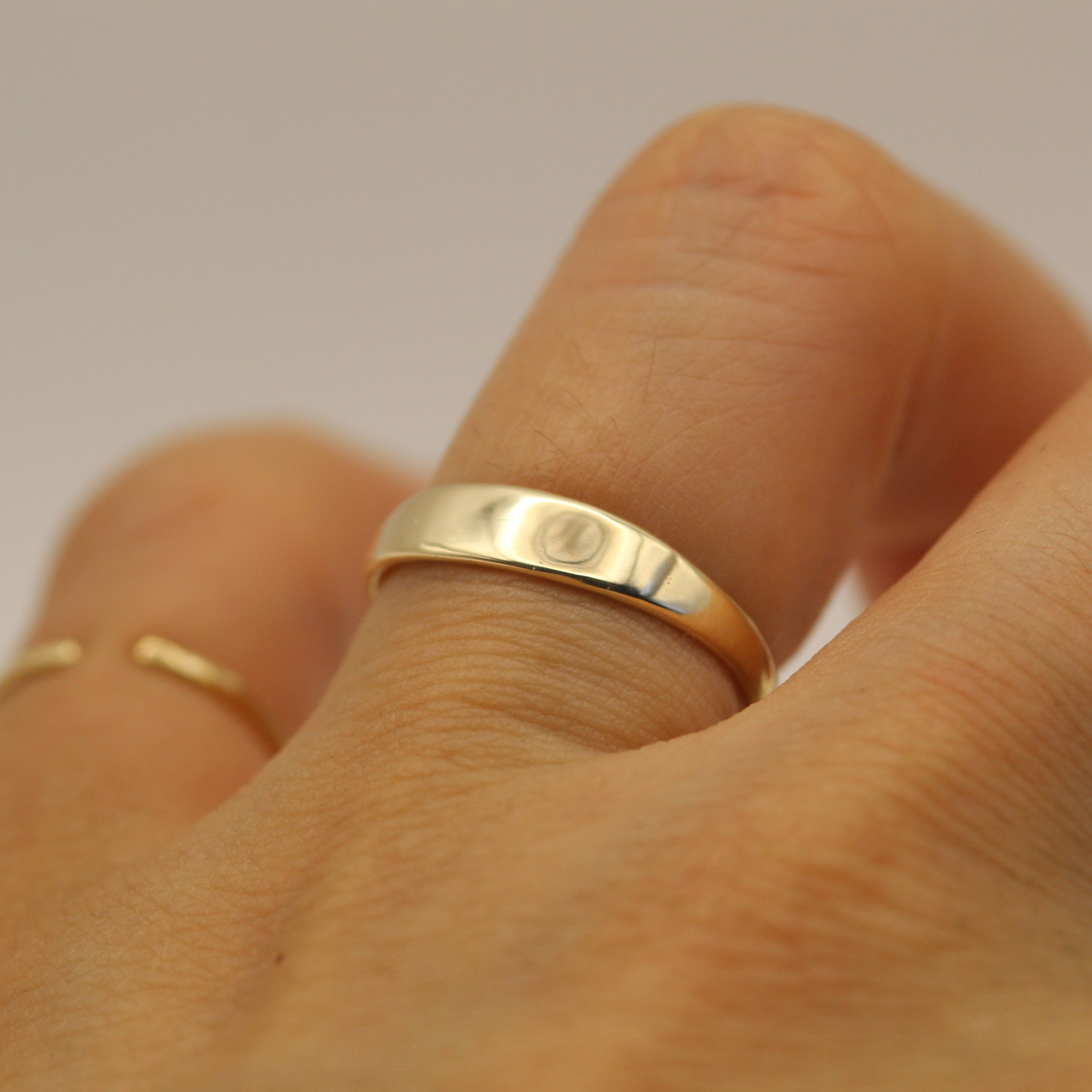 Elegant curved gold band symbolizing softness and inner strength