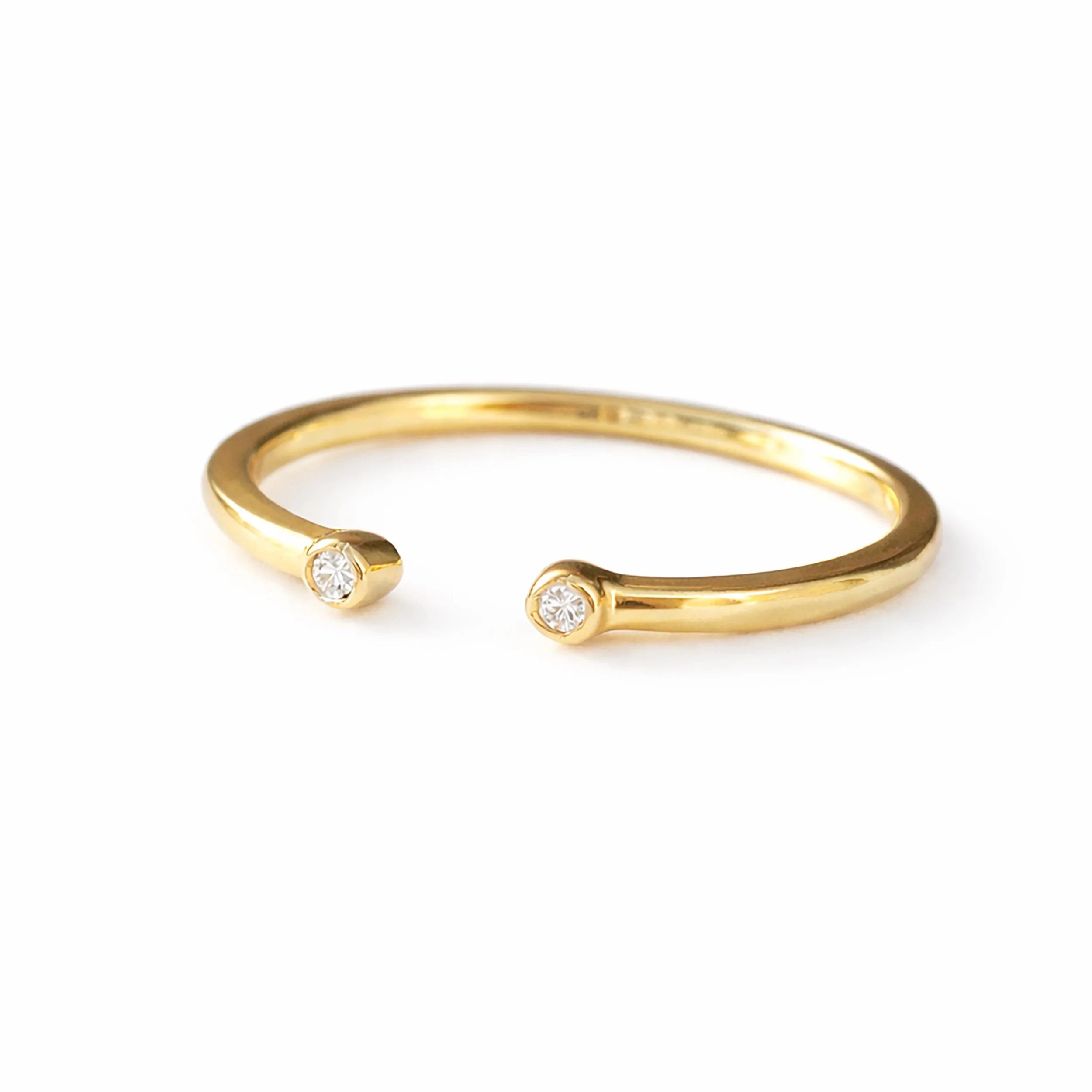 Minimalist open cuff ring in Yello gold with two bezel-set diamonds, delicate dainty open ring, modern fine jewelry for everyday wear, elegant stacking ring for.jpg