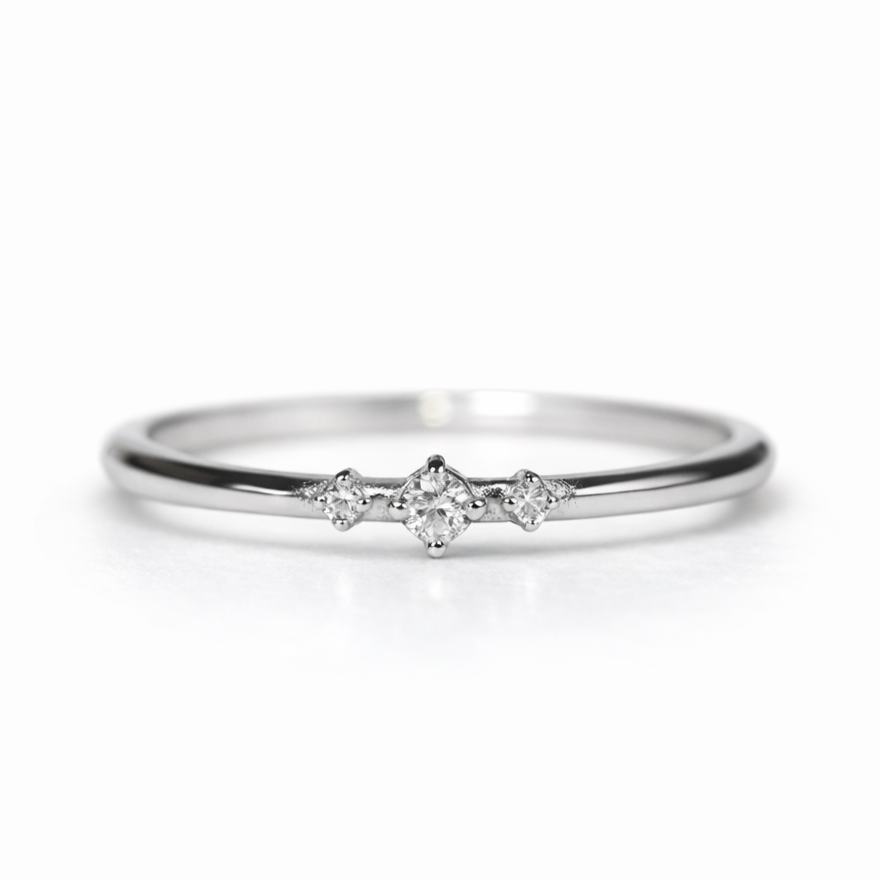 Delicate 14K gold three stone diamond ring worn on hand, thin band minimalist stacking ring with brilliant clear diamonds, perfect gift for her