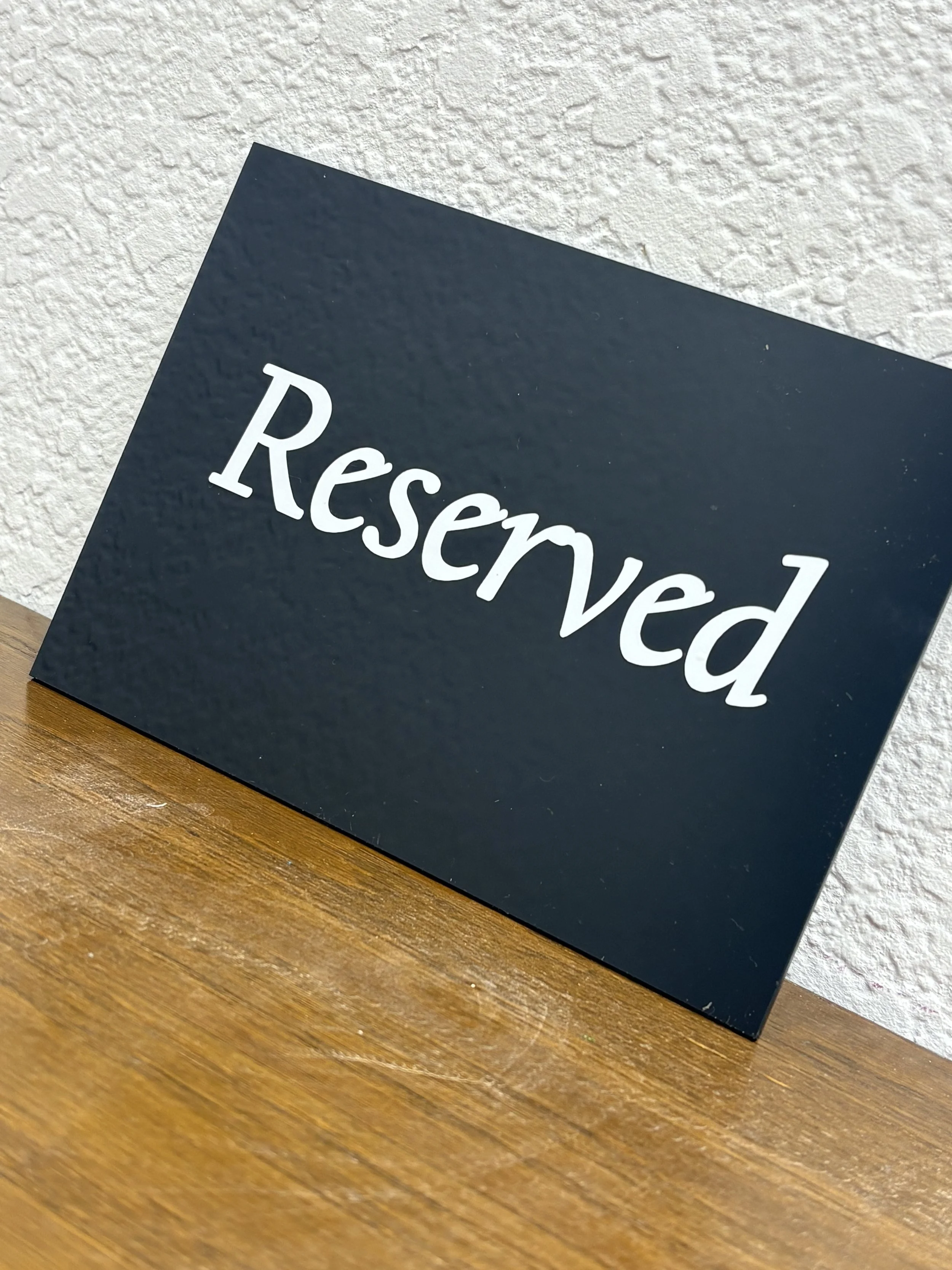 black acrylic reserved sign