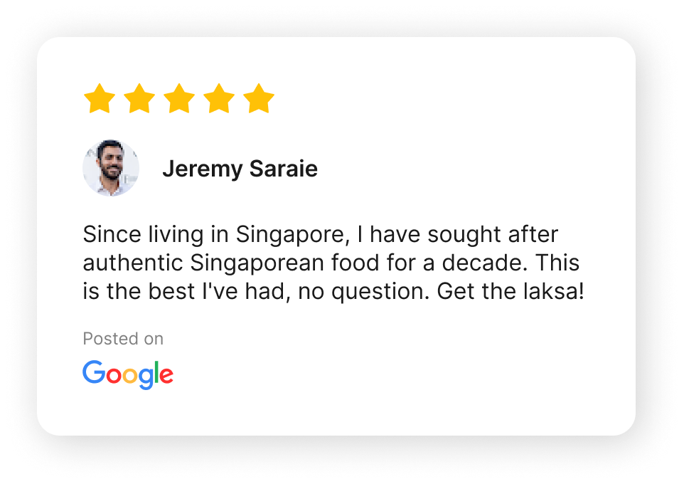 A screenshot of a Google review with five gold stars, a profile picture of a man with dark hair and a beard, and the name Jeremy Saraie. The review praises authentic Singaporean food, specifically mentioning laksa, and is posted on Google.