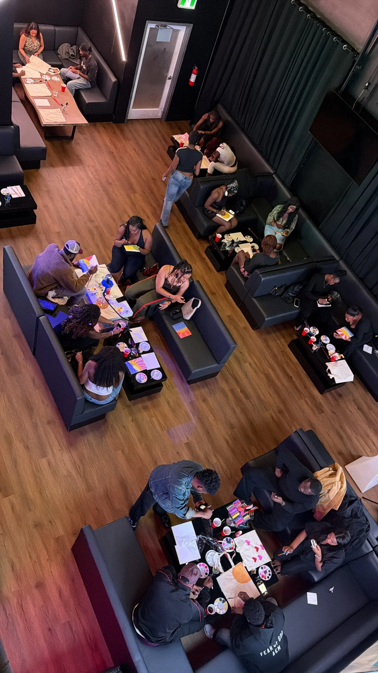 Overhead view of guests at tables at a Toronto paint and sip night.
