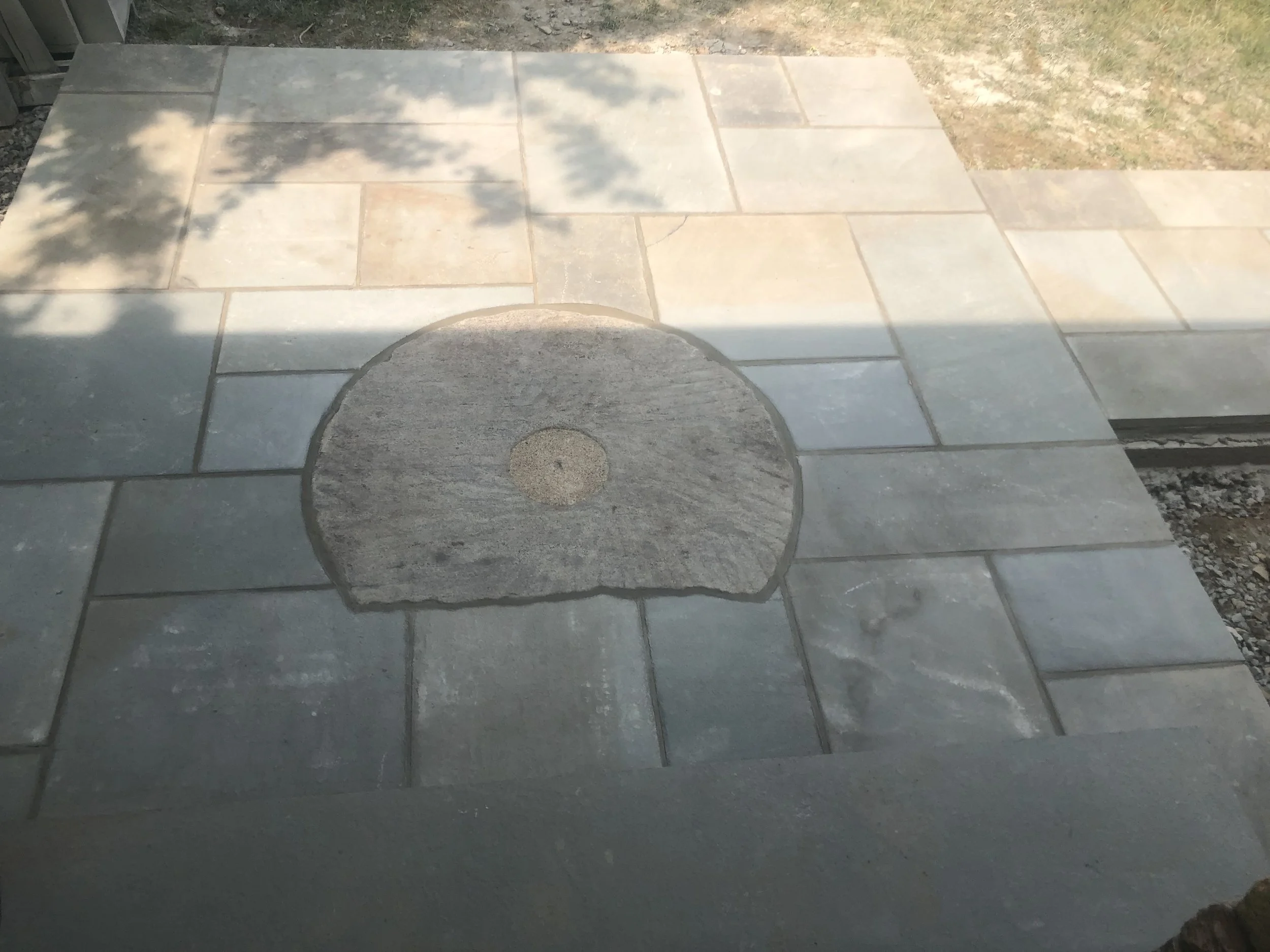 Blue stone with old millstone stone used as part of design per request of homeowner