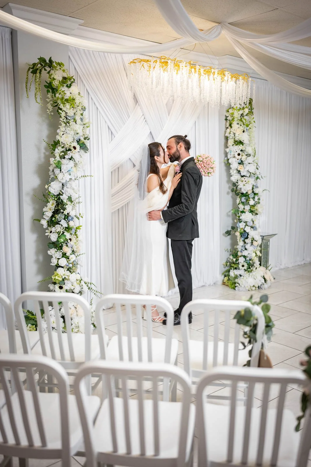 A bride and groom kissing during their wedding ceremony at the Say I Do Wedding Chapel in Las Vegas.