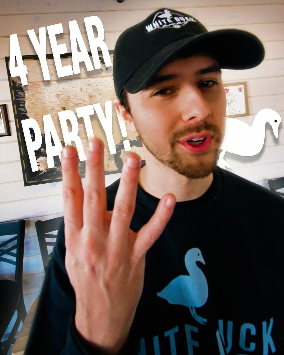 Person outdoors wearing a "Baxter Brewing Co." cap, holding a box of Baxter Blueberry Ale, smiling in a field with trees in the background.