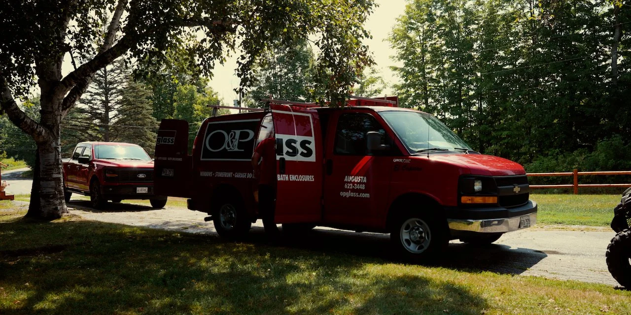 A man sitting in an office with certificates on the wall.