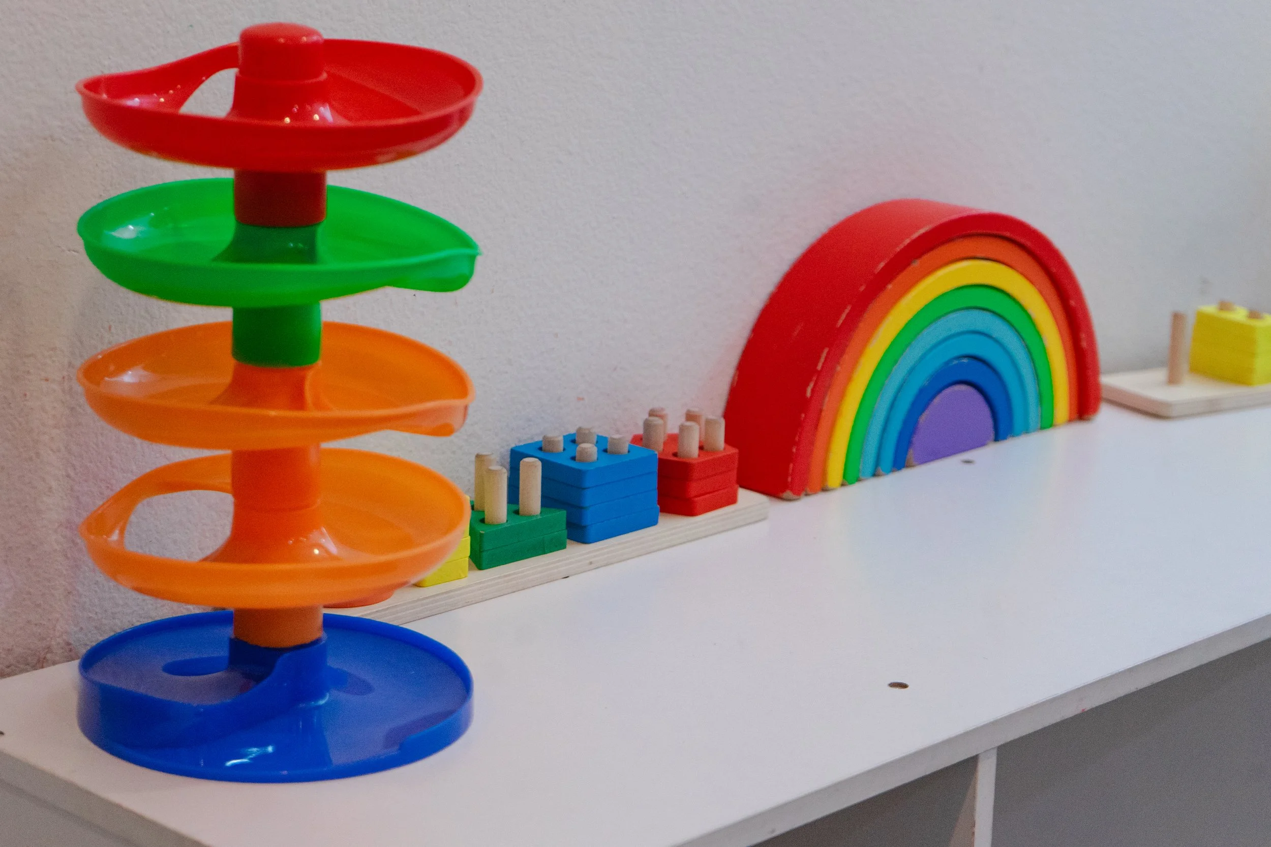 Child-friendly daycare space with age-appropriate toys, learning materials, and open areas that encourage exploration, social development, and hands-on learning.