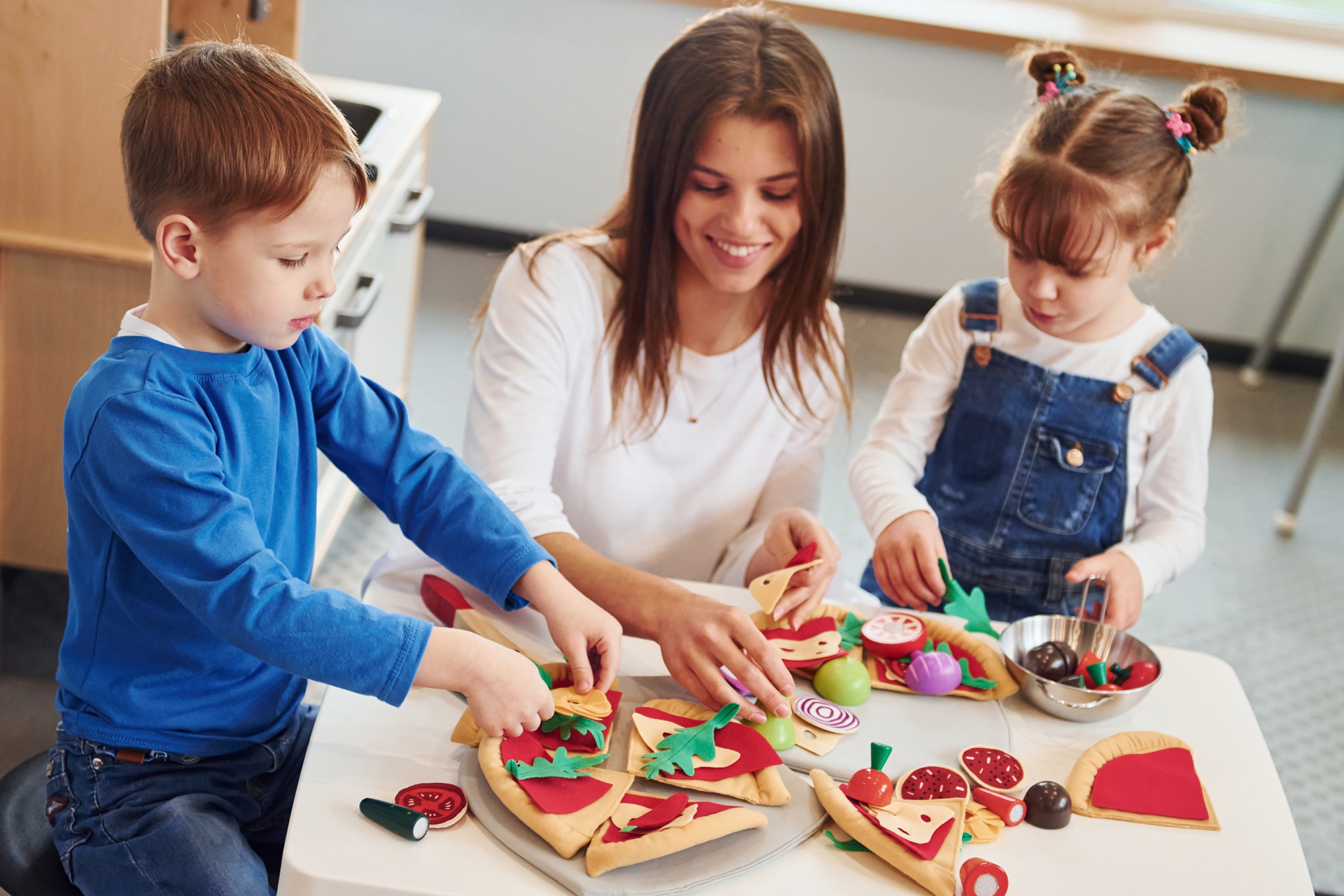 young-woman-with-little-boy-and-girl-playing-with-2025-03-18-20-12-39-utc.jpg