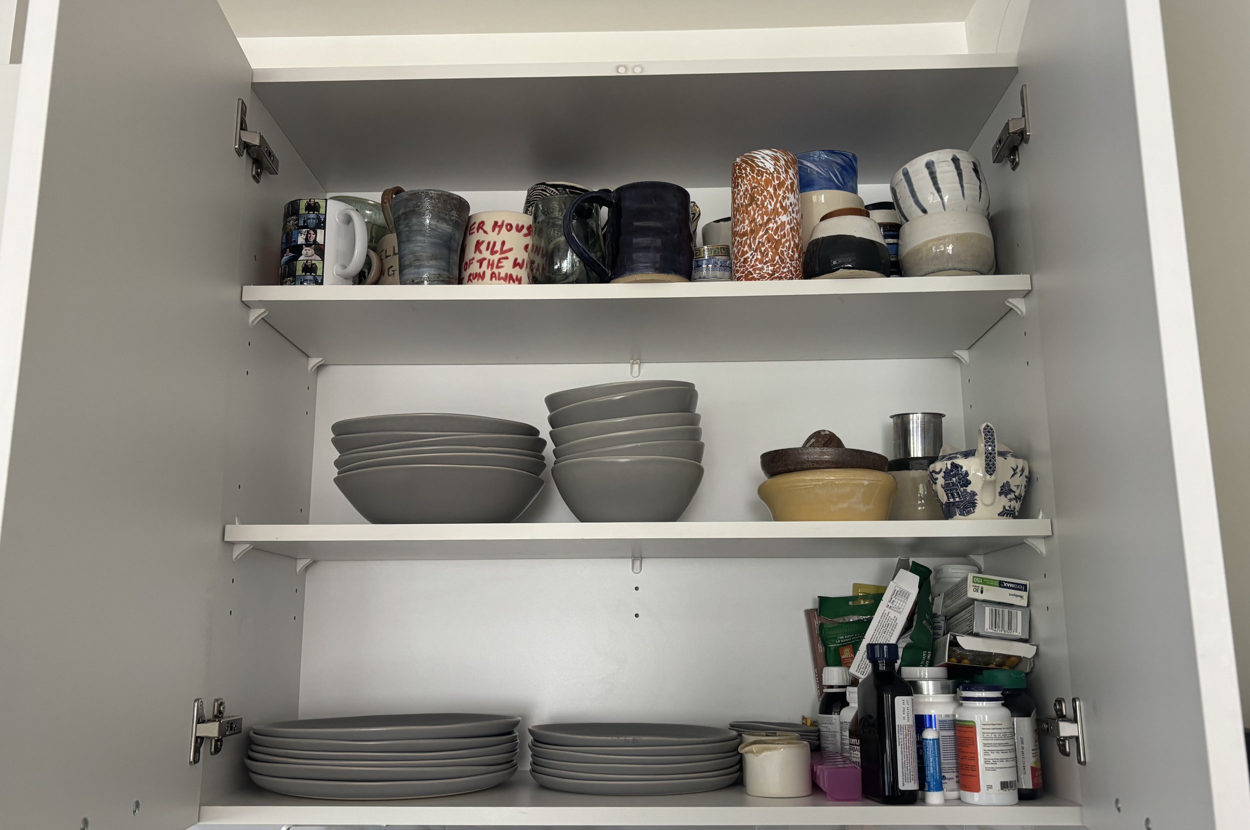 BEFORE - MAIN CUPBOARD - Our client wanted a dedicated tea zone, so we made more space in the pantry for a bin of backup mugs for seasonal swapping.