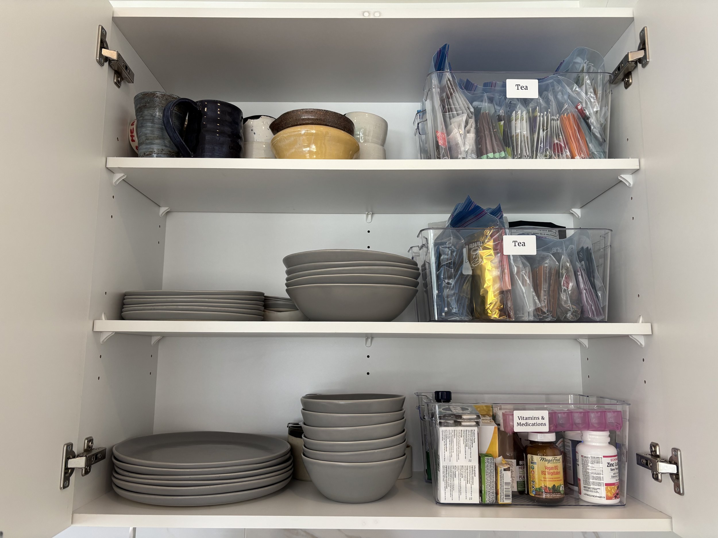 AFTER - MAIN CUPBOARD - With over 30 teas, we used labeled Ziploc bags to “file” the tea - a simple, space-saving solution that makes it easy to find and put away tea.