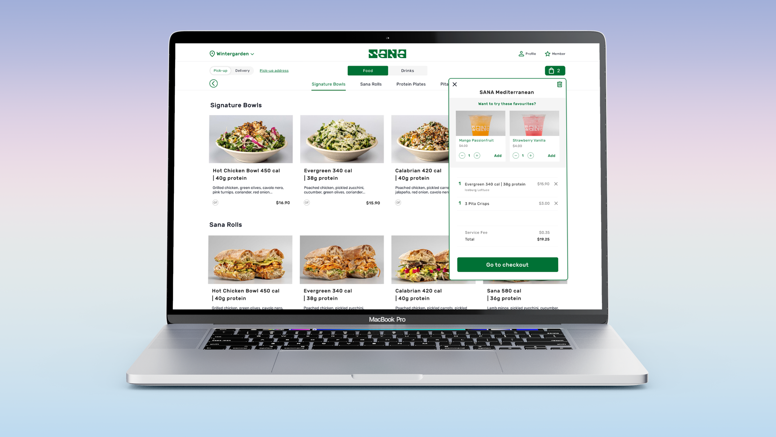 Laptop screen displaying an online food ordering website with menu items like signature bowls and wraps, and a checkout summary for Mediterranean items including mango passionfruit and strawberry vanilla drinks.