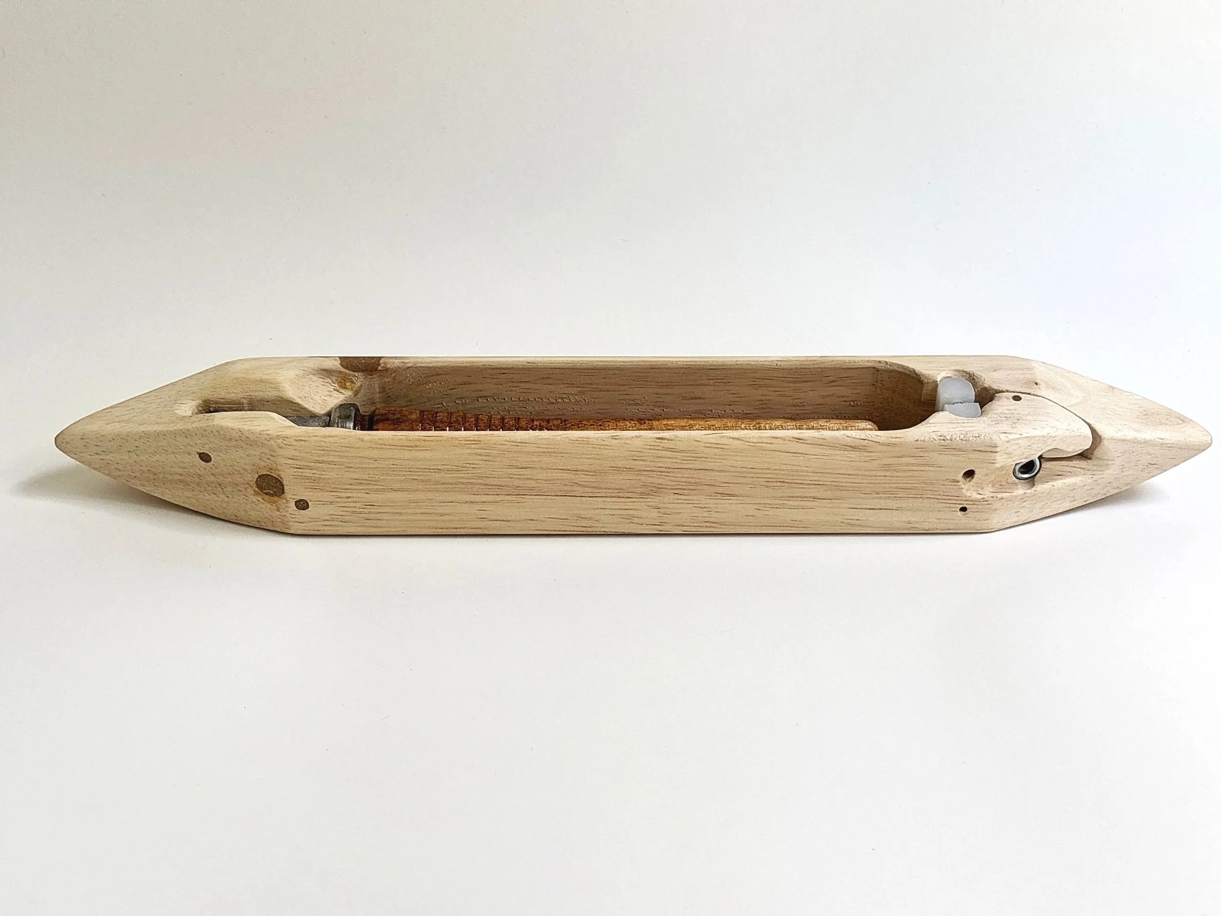 Leclerc Canadian maple end-feed shuttle with wood pirn loaded in the tension device