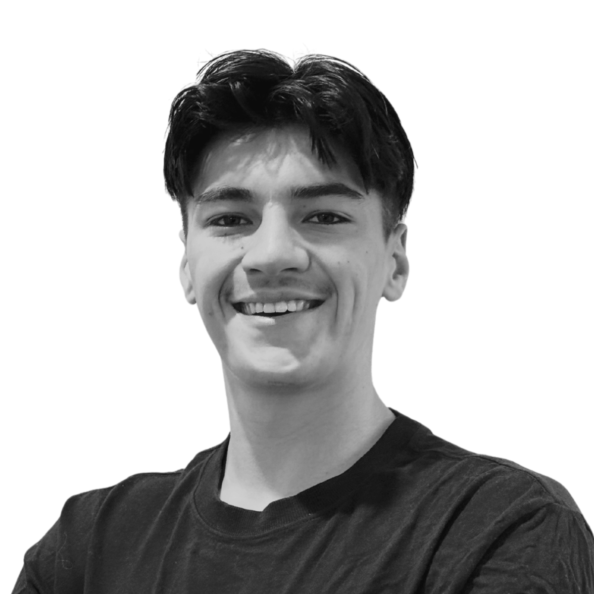 Black and white photo of a young man smiling, with short dark hair, wearing a dark t-shirt, posed against a plain white background.