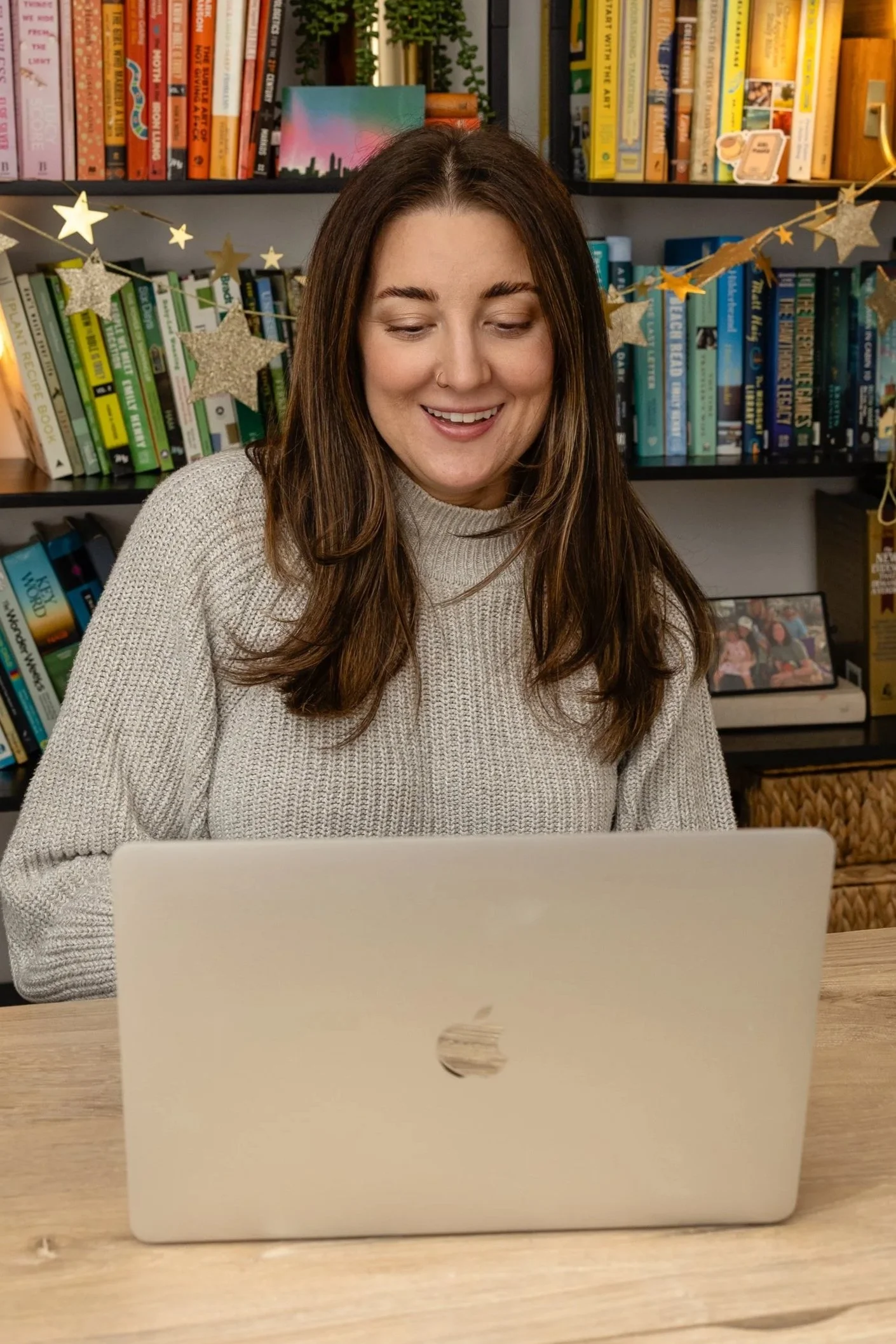 Lauren Harvey of The Sleep Edit sitting in a nursery in front of a crib, providing newborn care and sleep consulting services in Atlanta.