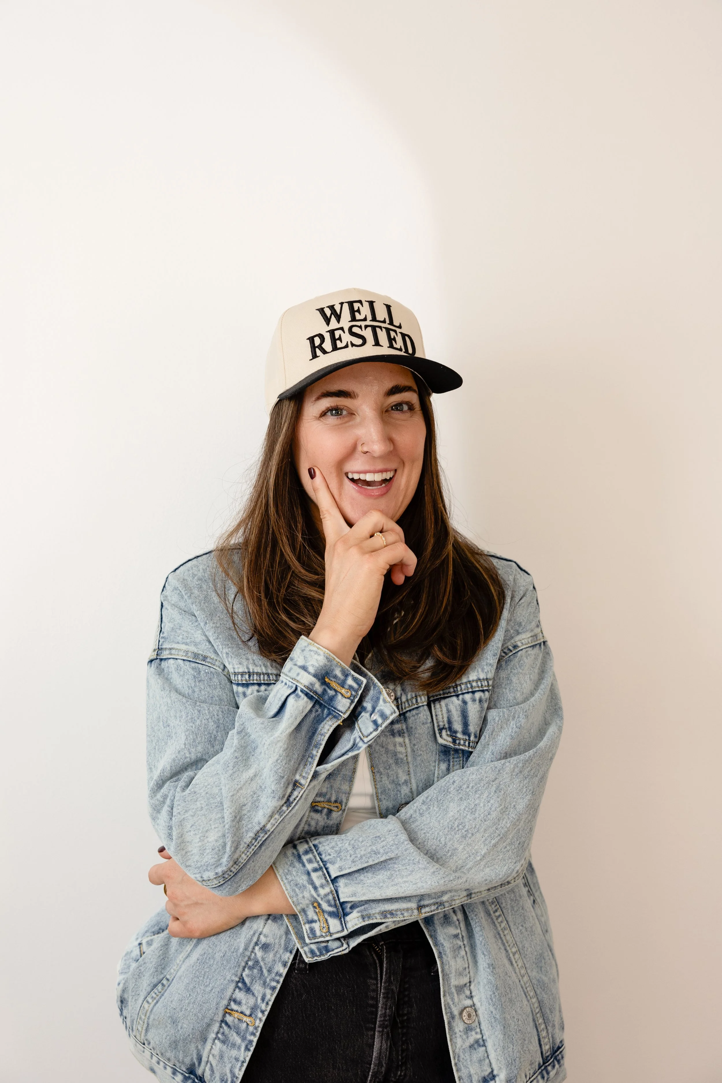 Pediatric sleep consultant Lauren Harvey wearing a Well Rested hat and helping families build healthy sleep habits.