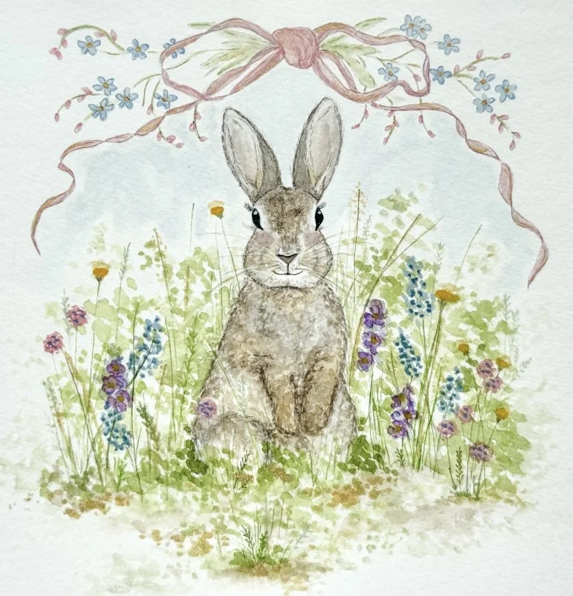 Whimsical illustration of a rabbit sitting among wildflowers beneath a decorative ribbon and bow