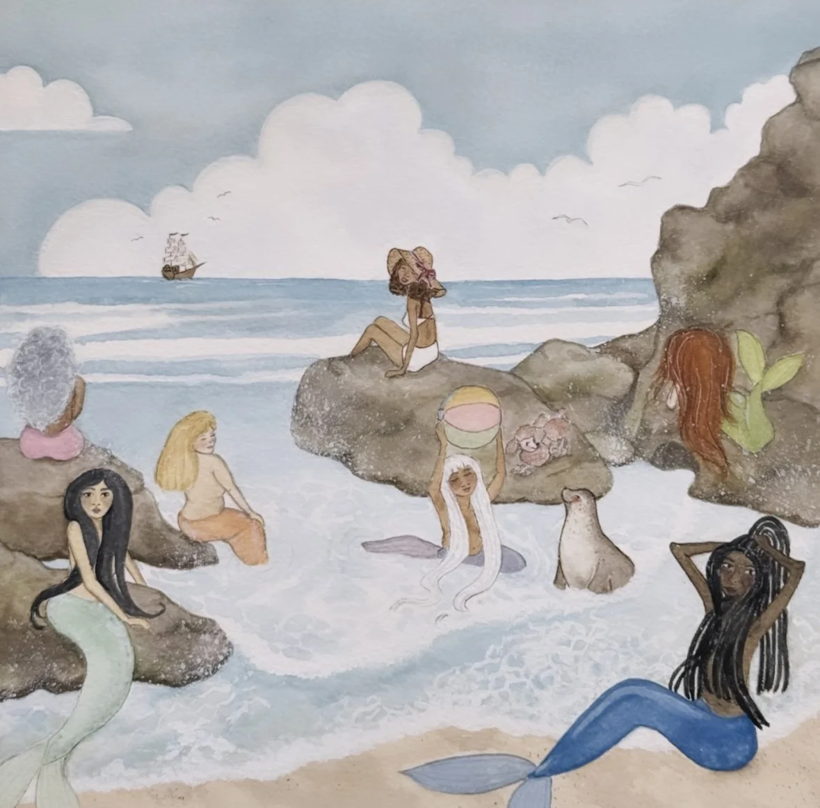 Whimsical illustration of mermaids gathered along a rocky shoreline, gazing toward the sea under a soft sky.