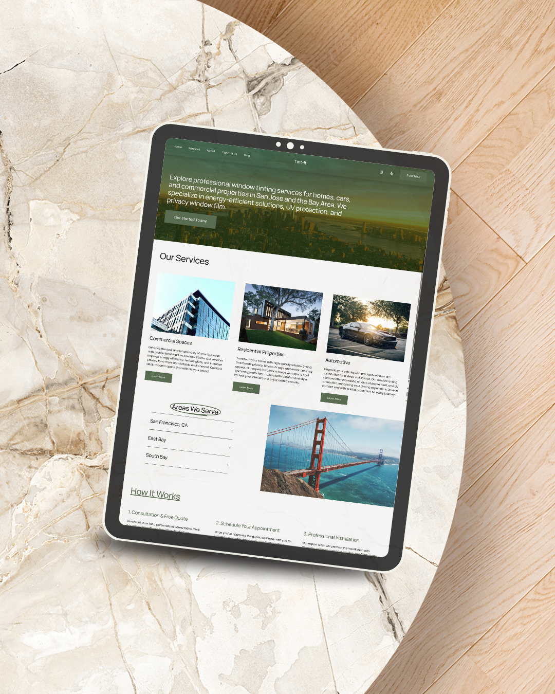 A tablet displaying a website about professional window tinting services, placed on a marble and wooden surface.