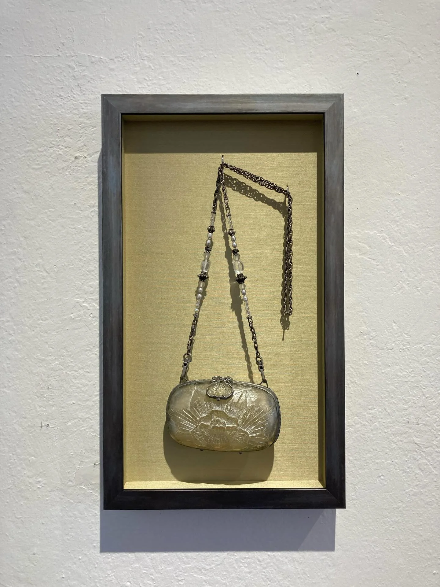 What can you do with a beautiful purse that lets you enjoy it even when you are not using it?  Hang it in an open shadowbox so it is on display as a piece of art!  Here it is hanging on a couple of hooks, against a fabric background, so it is easily 