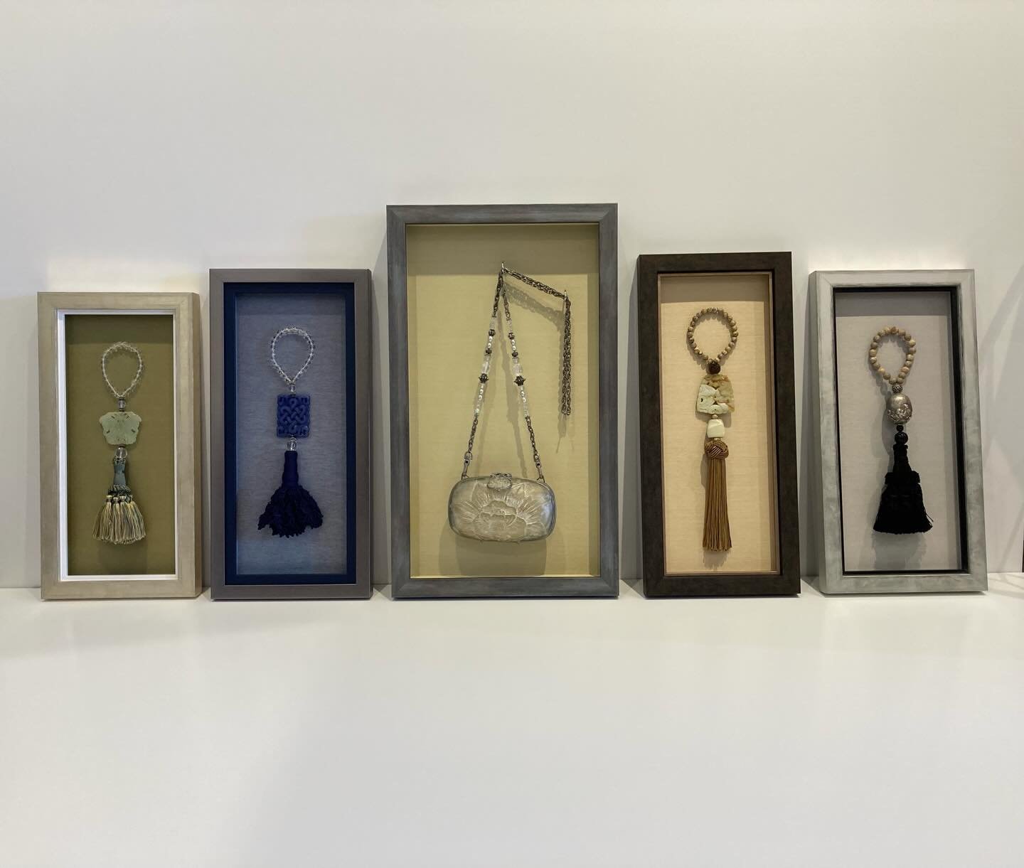 This is a fun collection of open shadowboxes, including a purse and 4 decorative door adornments.  The purse is removable, held in by a couple of hooks.  All of them are framed a little differently so that each piece can have its own personality whil