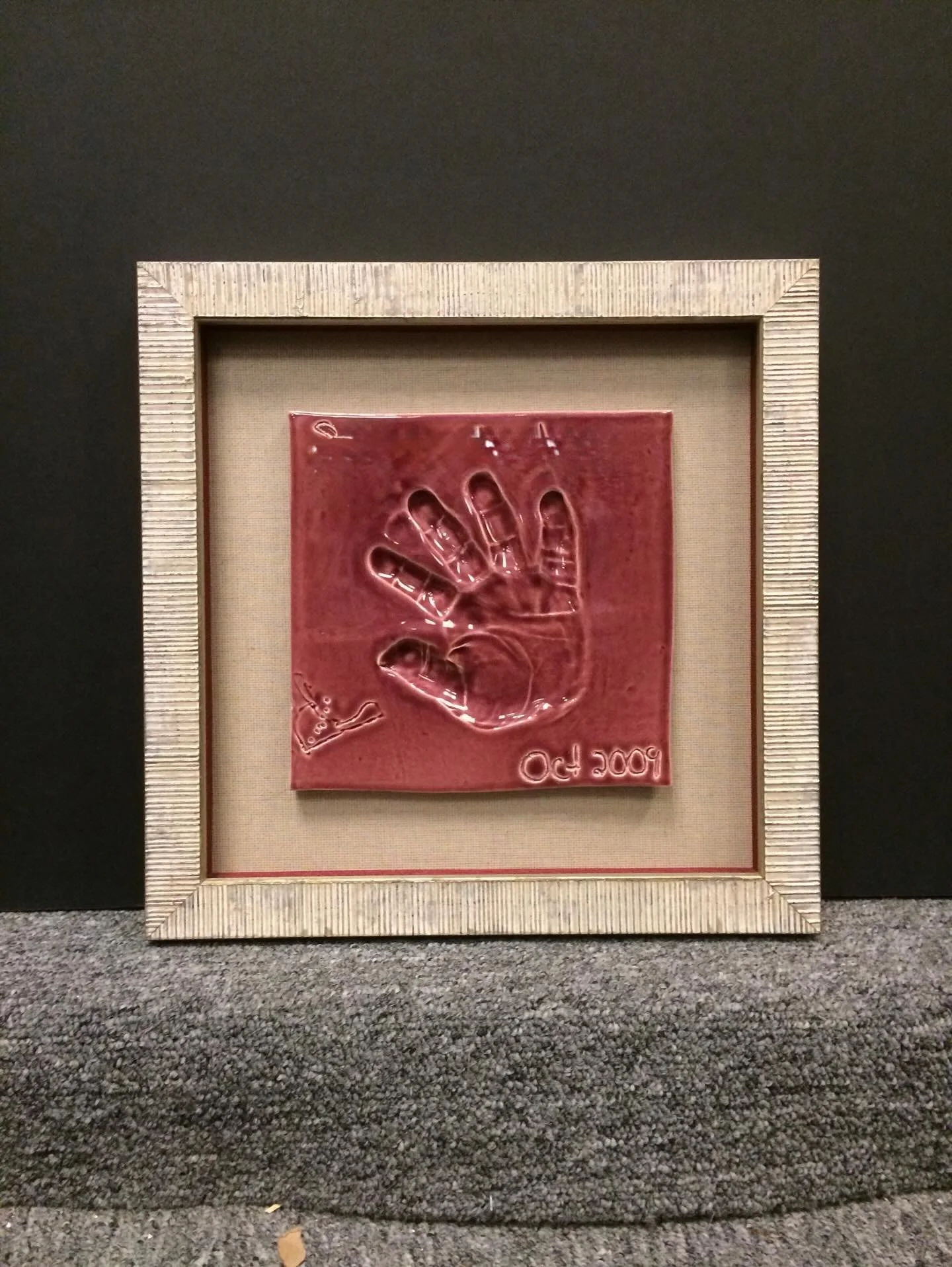 What do you do with those cute ceramics that your kids make in school?  Put them in sweet little shadowboxes and make a fun collage as an art display.  Not only do you get to look at art that makes you smile everyday, it will also make your kids feel