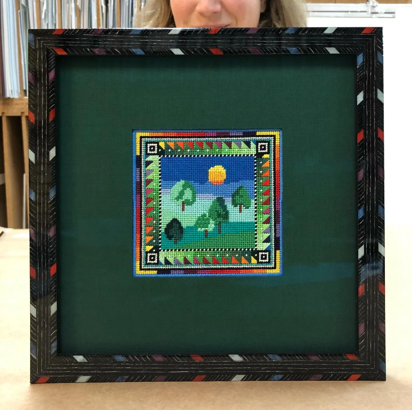 Have fun with patterns!  We have a great selection of Italian inlaid lacquer frames with lots of fun patterns.  This frame from Bella was used on this colorful needlepoint.  It has the black base with the fun little dashes in different colors.
#frame