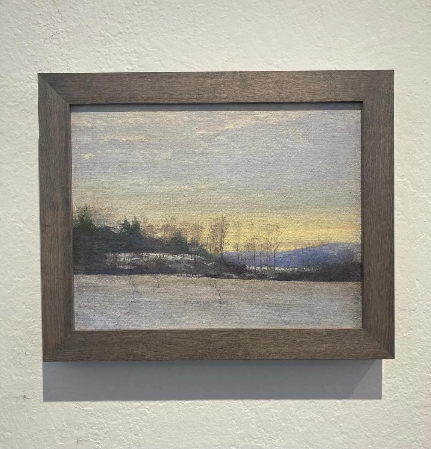 Simple doesn&rsquo;t have to mean boring.  The focus on this soft winter landscape would be taken away by a frame with too much carving or color.  We used a larger Picture Woods frame in the maple with country gray stain.  The maple grain is very sof