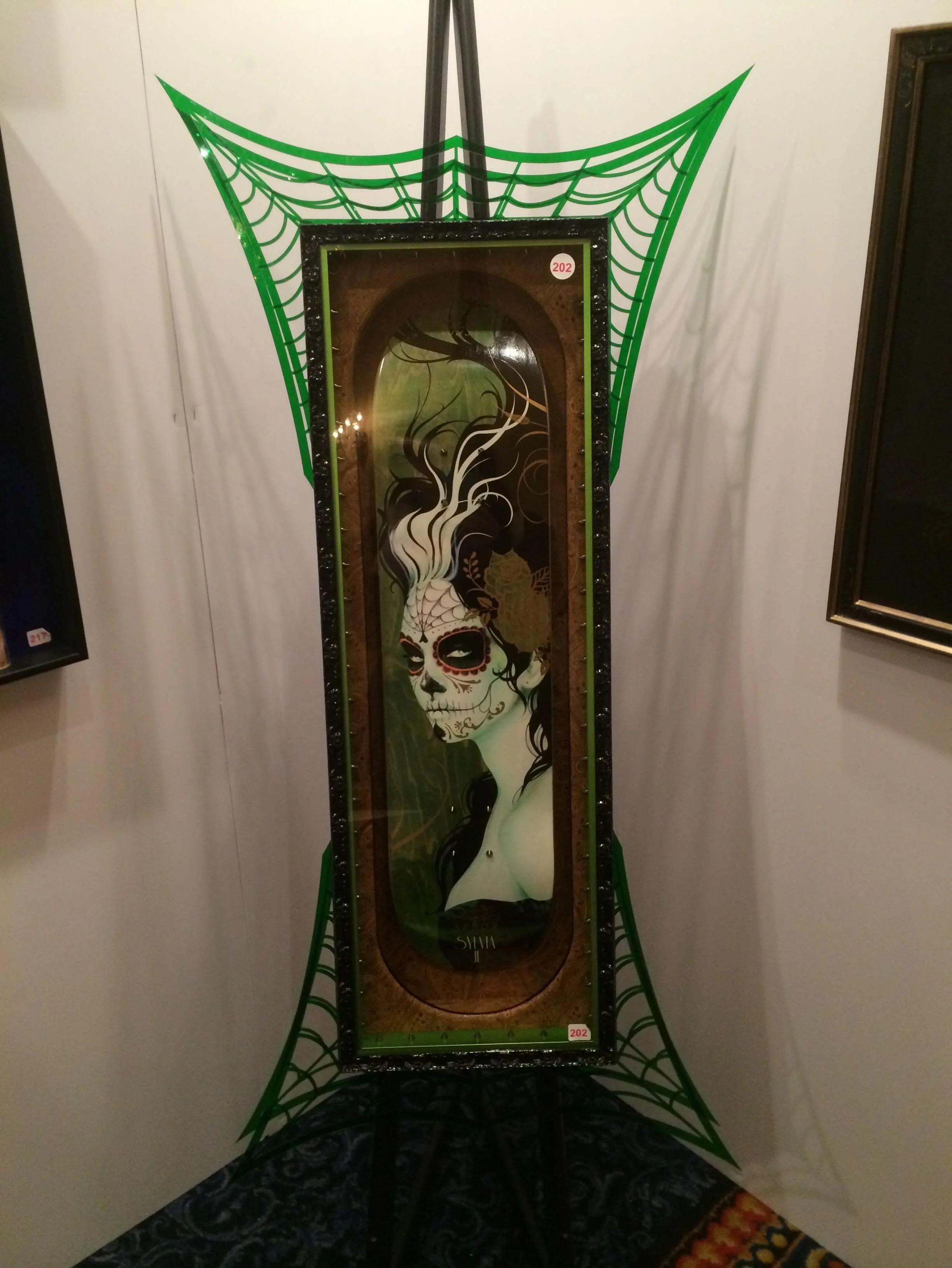 I saw this in Las Vegas about 20 years ago and I am still so impressed by this framer&rsquo;s creativity!  It is a skateboard painted by Sylvia Ji, one of my favorite artists.  There are several frames, what looks like leather, cut colored acrylic an