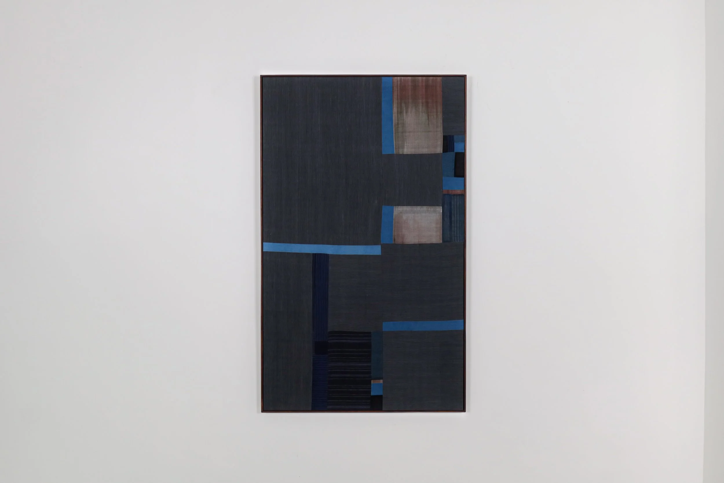 Textile work titled “Parts of the Forest XII”, 2021, stitched handwoven indigo dyed cotton framed with reclaimed wood by A. Sebastianus, exhibiting artist at Sun Contemporary Gallery, Bali.