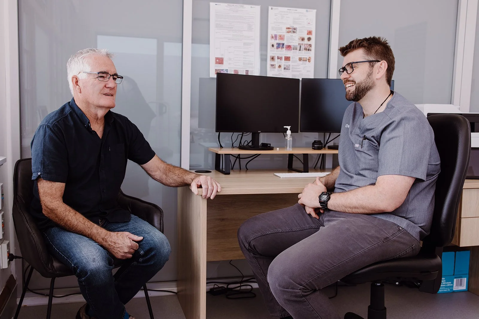 Dr Calum Stannett having a consultation with a patient at SkinScreen West Coast