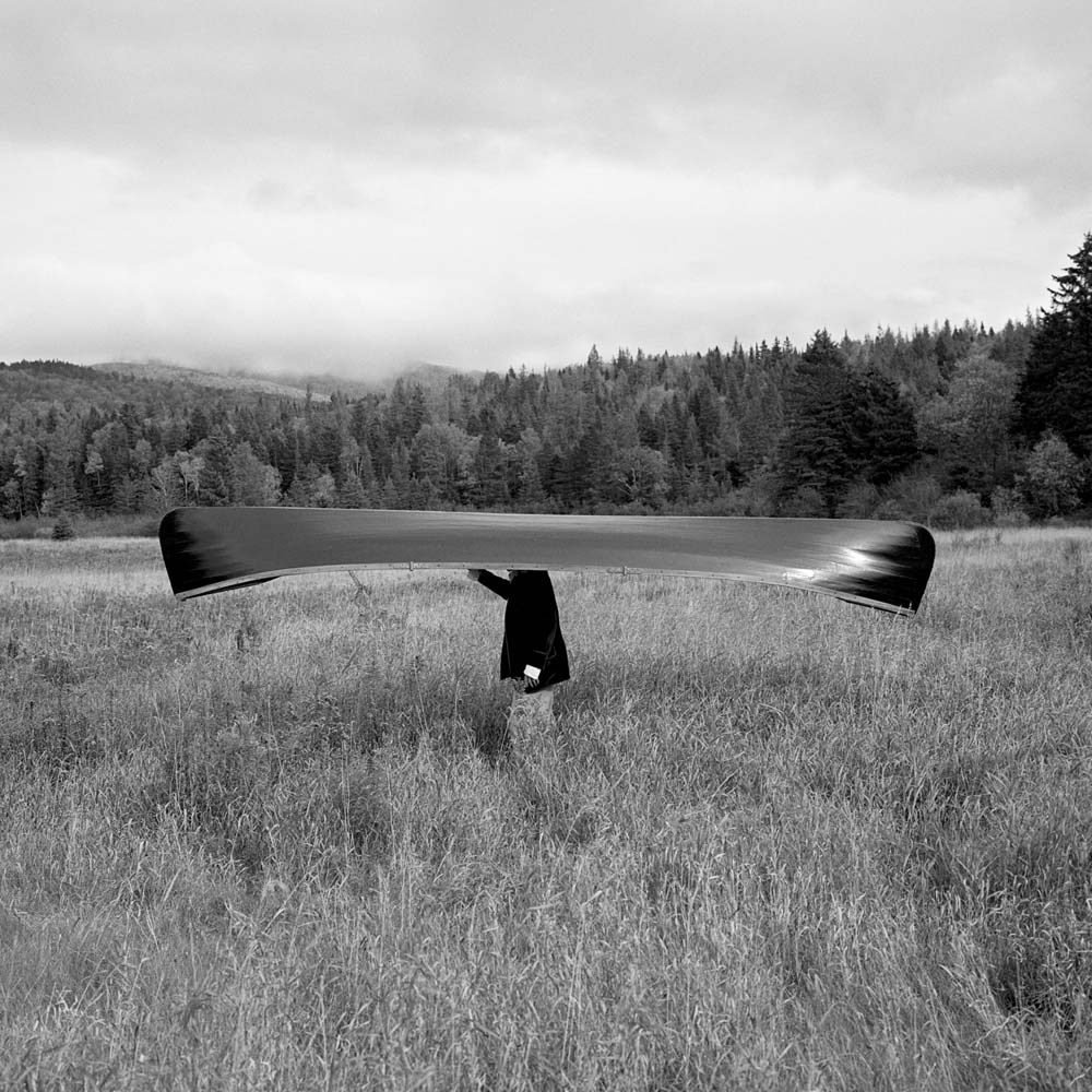 Rodney Smith, Man with Canoe on Head, Saranac, New York, 1994