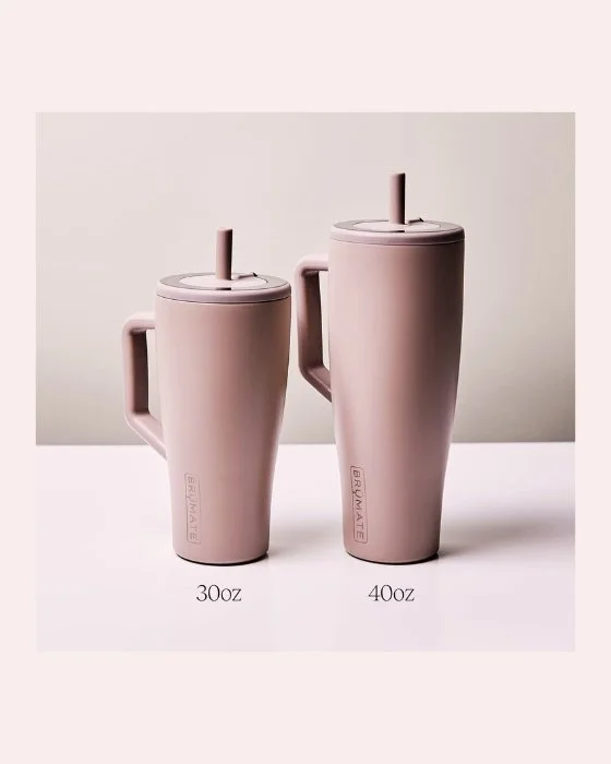 Two pink insulated tumbler cups with handles and straws, labeled 30oz and 40oz, on a white surface.