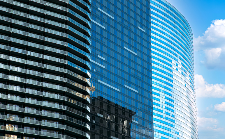 Modern glass skyscraper and residential building