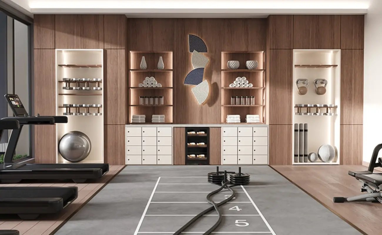Modern gym interior with treadmill, workout equipment, shelves with towels, and decorative wall art