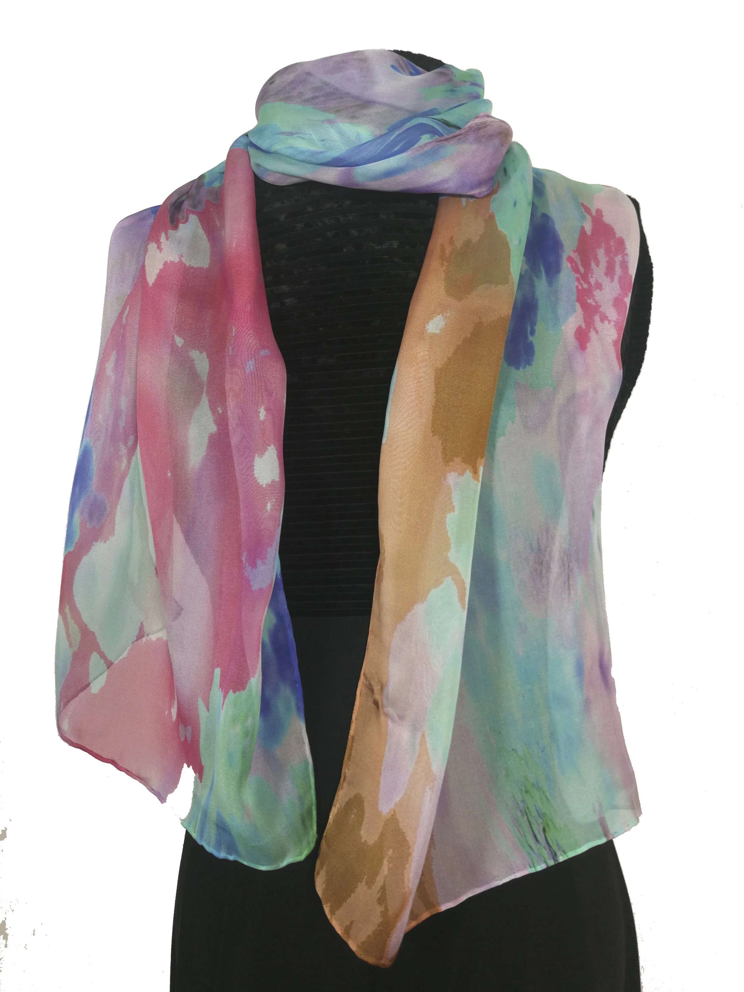 Black mannequin wearing a colorful, abstract-patterned silk scarf with shades of pink, purple, blue, green, and brown, draped over black clothing.