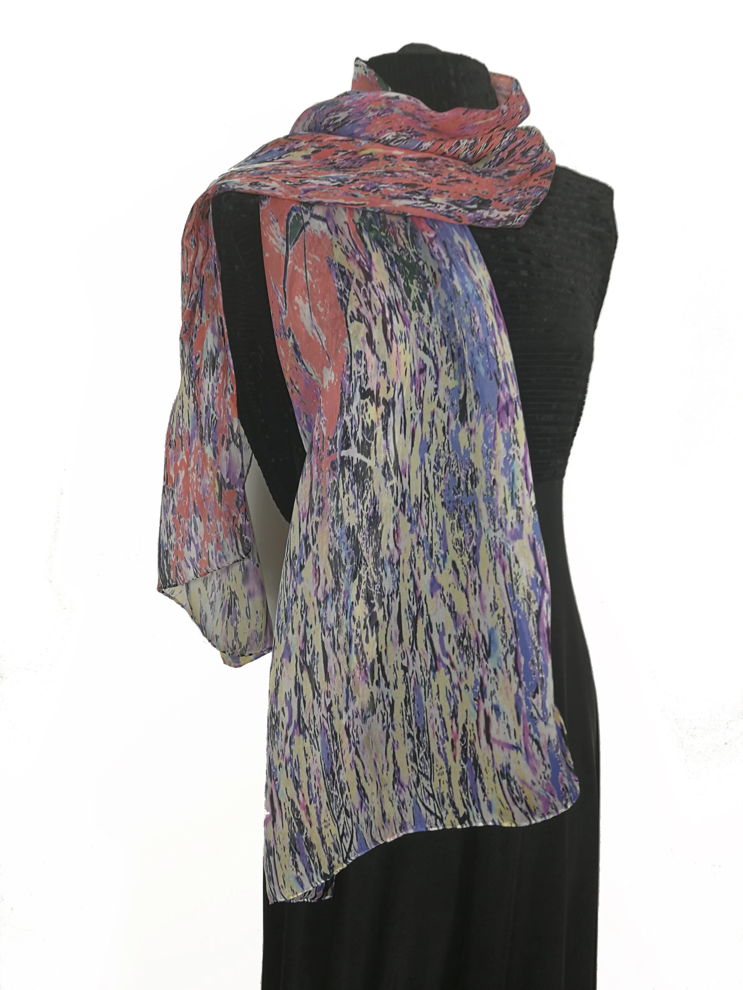 Dress on display with a colorful, patterned scarf draped over the shoulders.