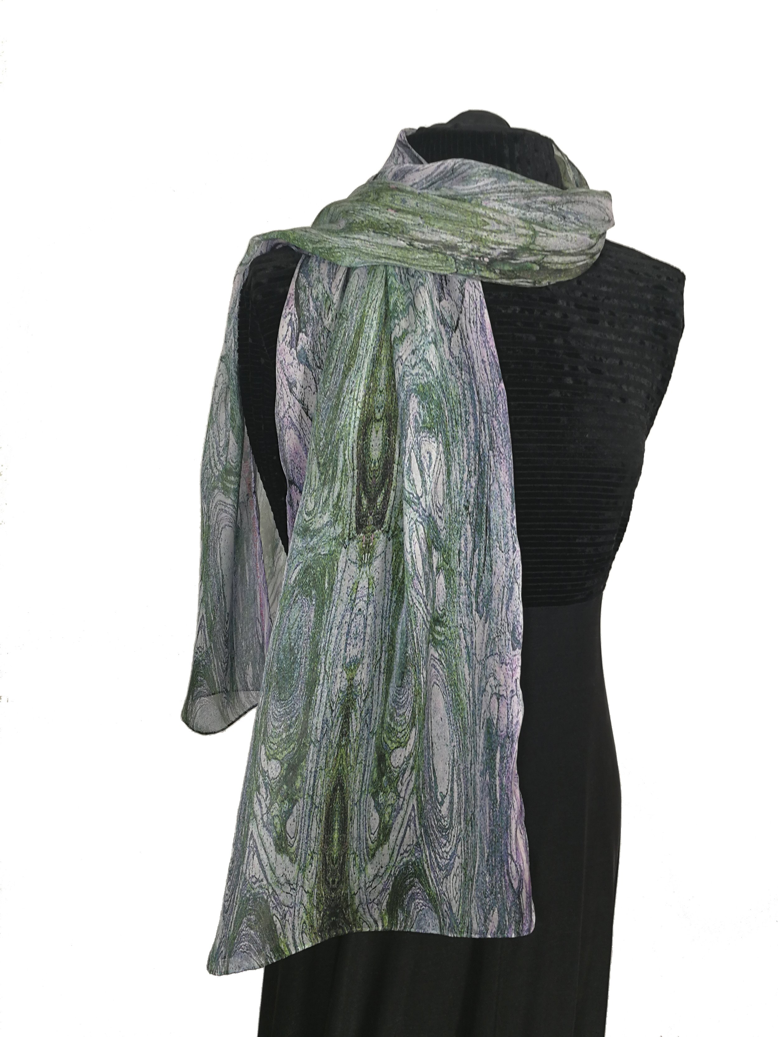 Mannequin dressed in black textured top with a sheer, colorful scarf with green, pink, purple, and white marbled pattern.