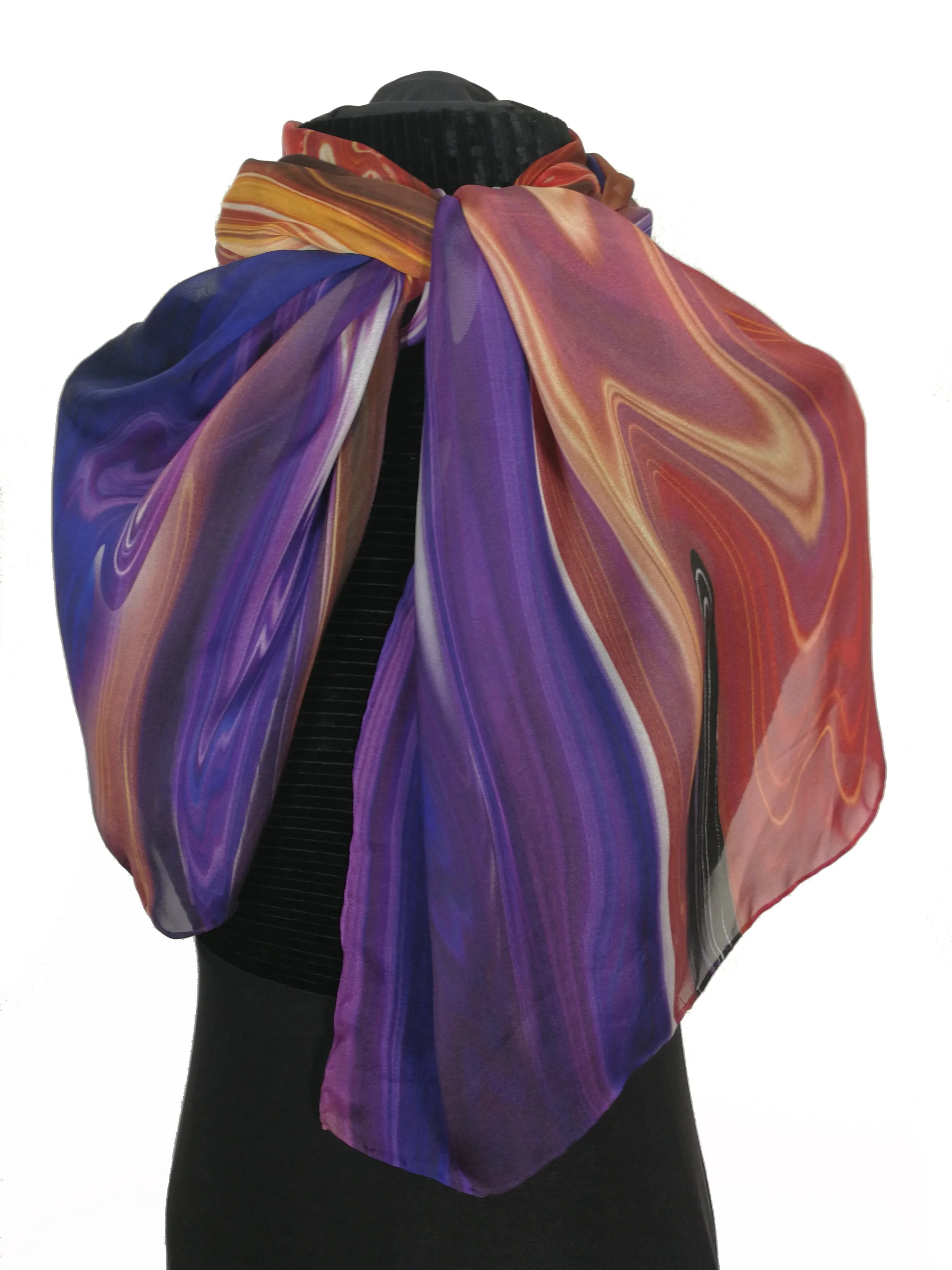 A person wearing a colorful, swirling-patterned, purple, red, orange, and yellow scarf