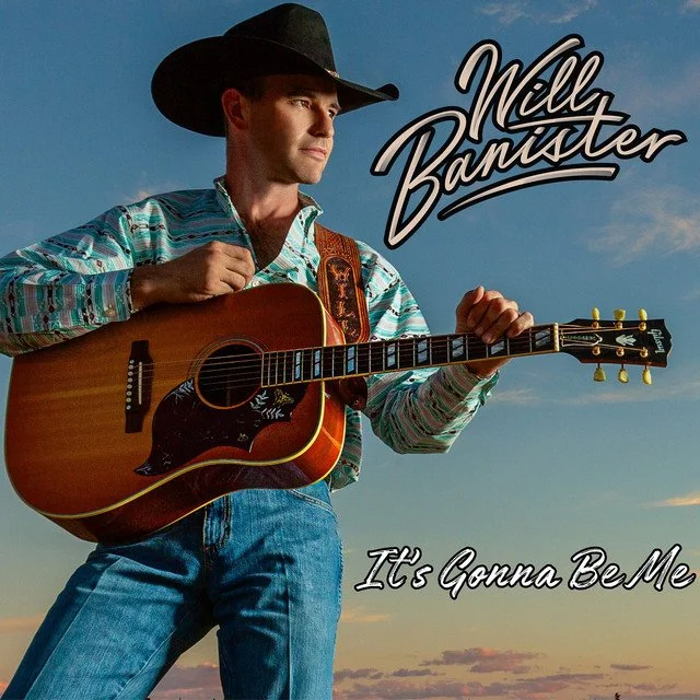 Young man wearing a cowboy hat, striped shirt, and jeans playing an acoustic guitar against a sunset sky, with the text 'Milly Bannister' and 'It's Gonna Be Me'.