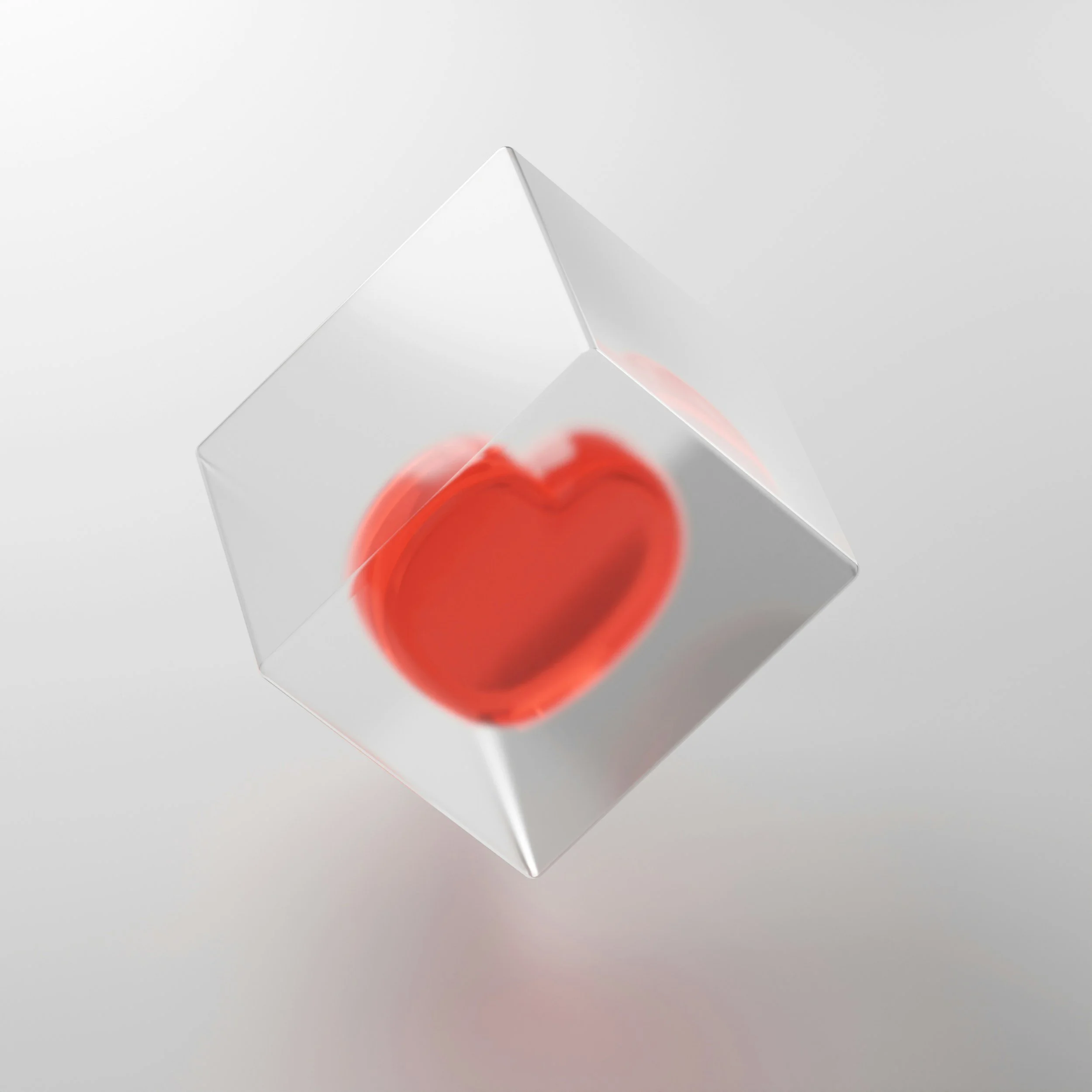 A transparent cube with a red heart inside floating against a white background.