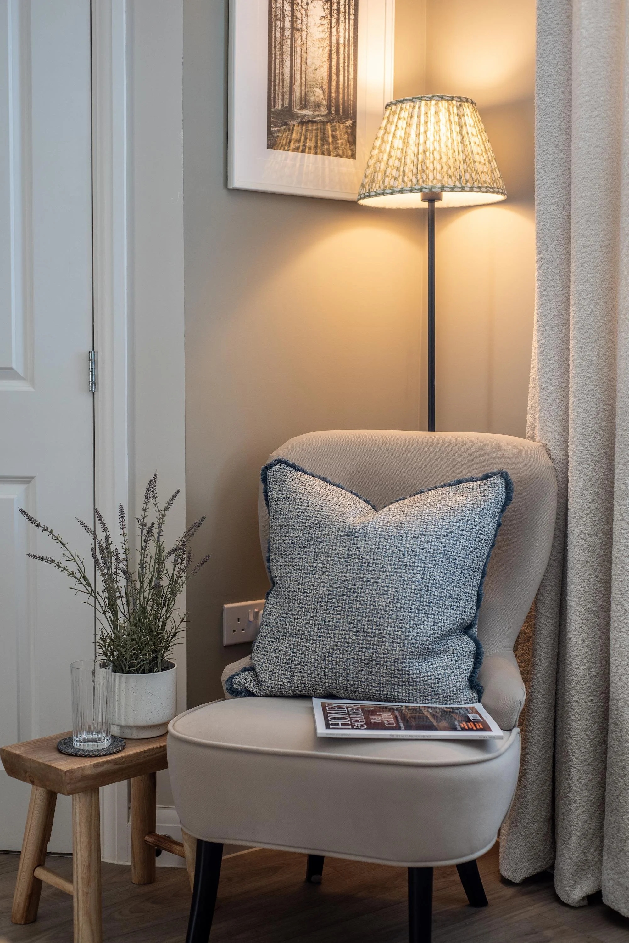Velvet accent chair with rustic wooden stool.
