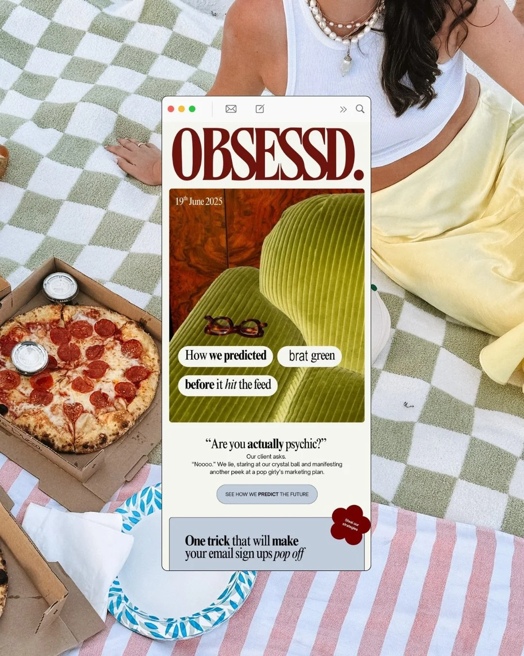 A woman sitting on a checkered blanket with a pizza box and drinks nearby, holding a magazine titled "OBSESSED." with a cover photo of green velvet chairs and glasses, and some text about prediction and psychic themes.