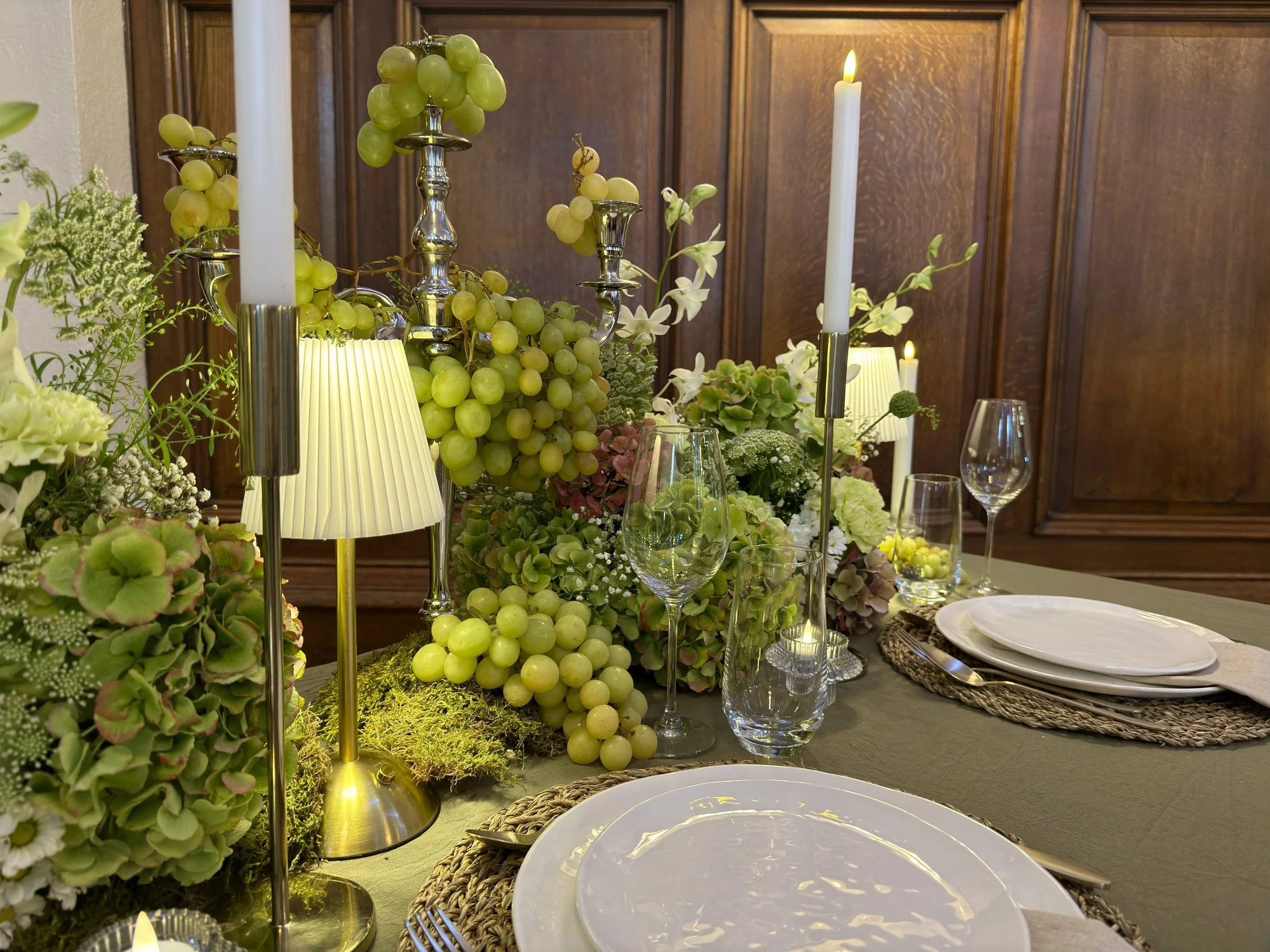 Styled table with green grapes and hydrangea