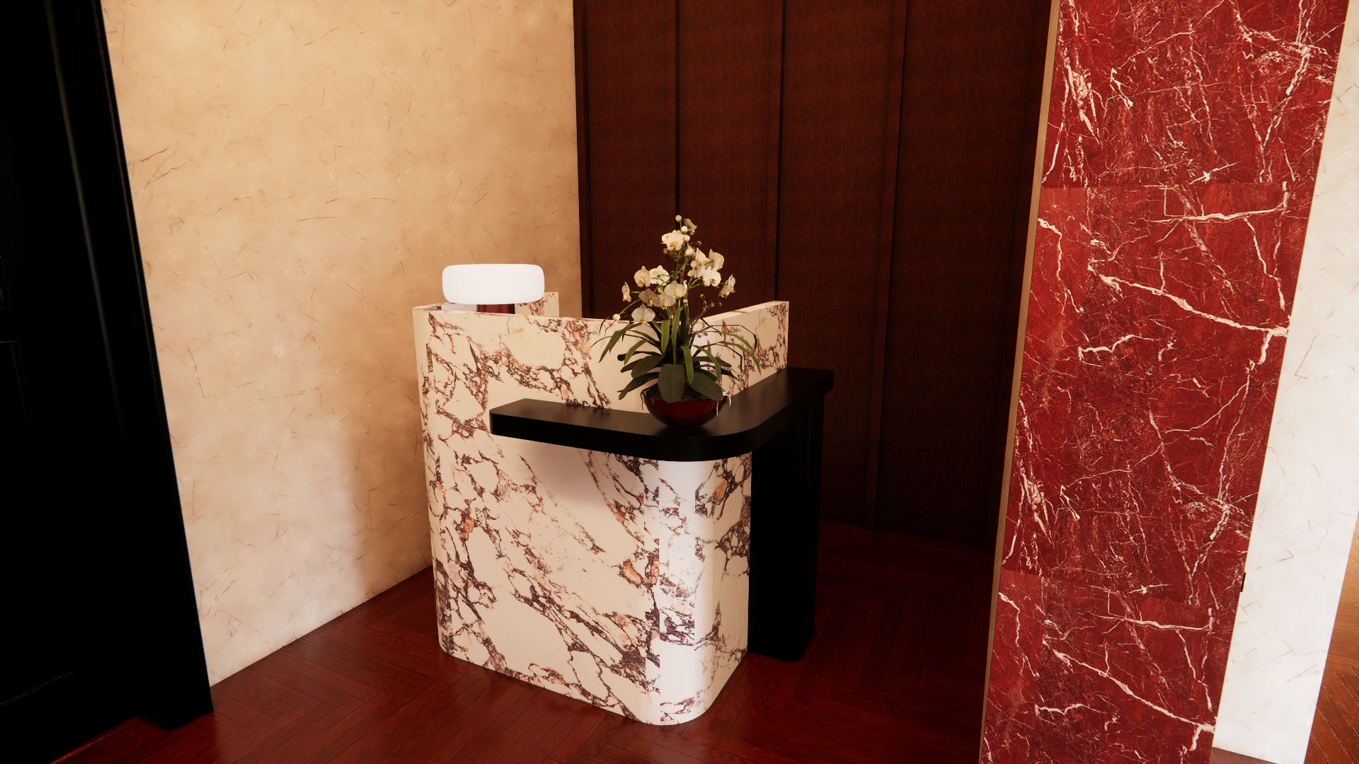 Interior of a building with a white marble reception desk accented with black, a potted flower on top, cream and red marble walls, and dark wood flooring.