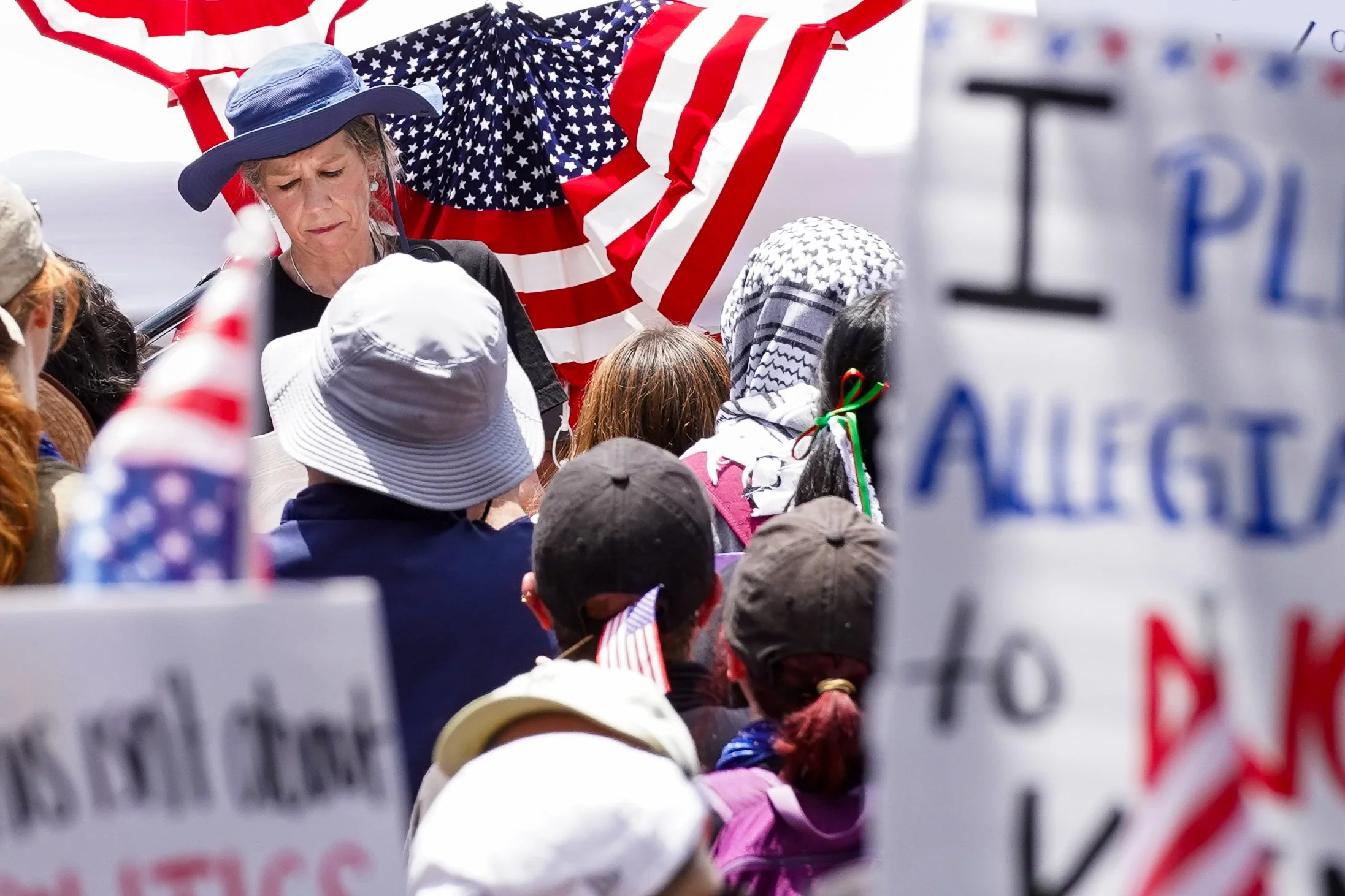 A speaker takes a moment to reflect on notes in her address to the crowd outside Dallas City Hall in Dallas, Texas during the nation-wide No-Kings Day protest on June 15, 2025.
